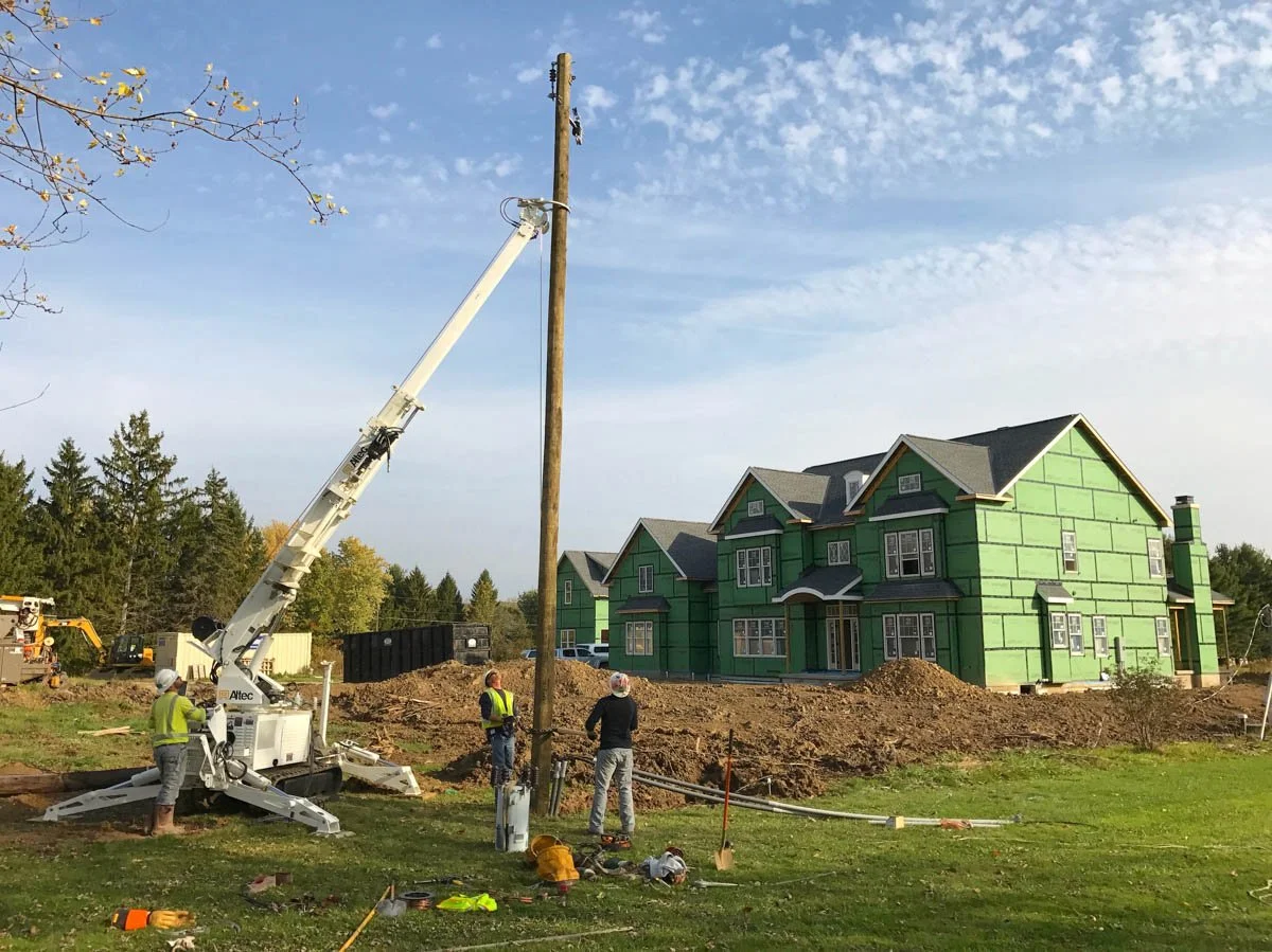 Utility pole installation at a custom home construction site in Northeast Ohio