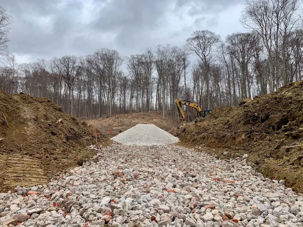 Excavator preparing a wooded building lot for construction in Northeast Ohio