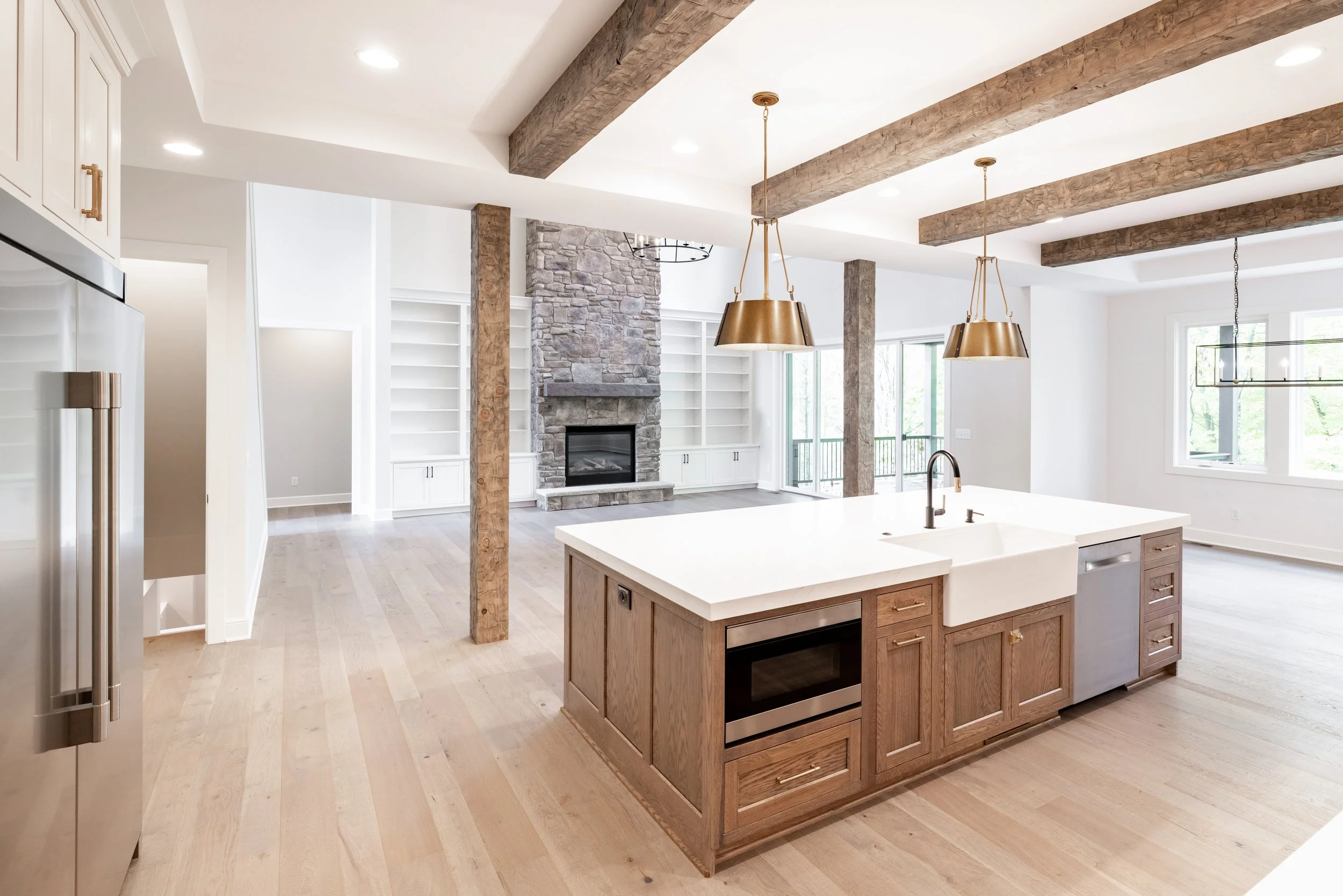 Open floor plan showing family room vs living room layout with shared fireplace and kitchen space