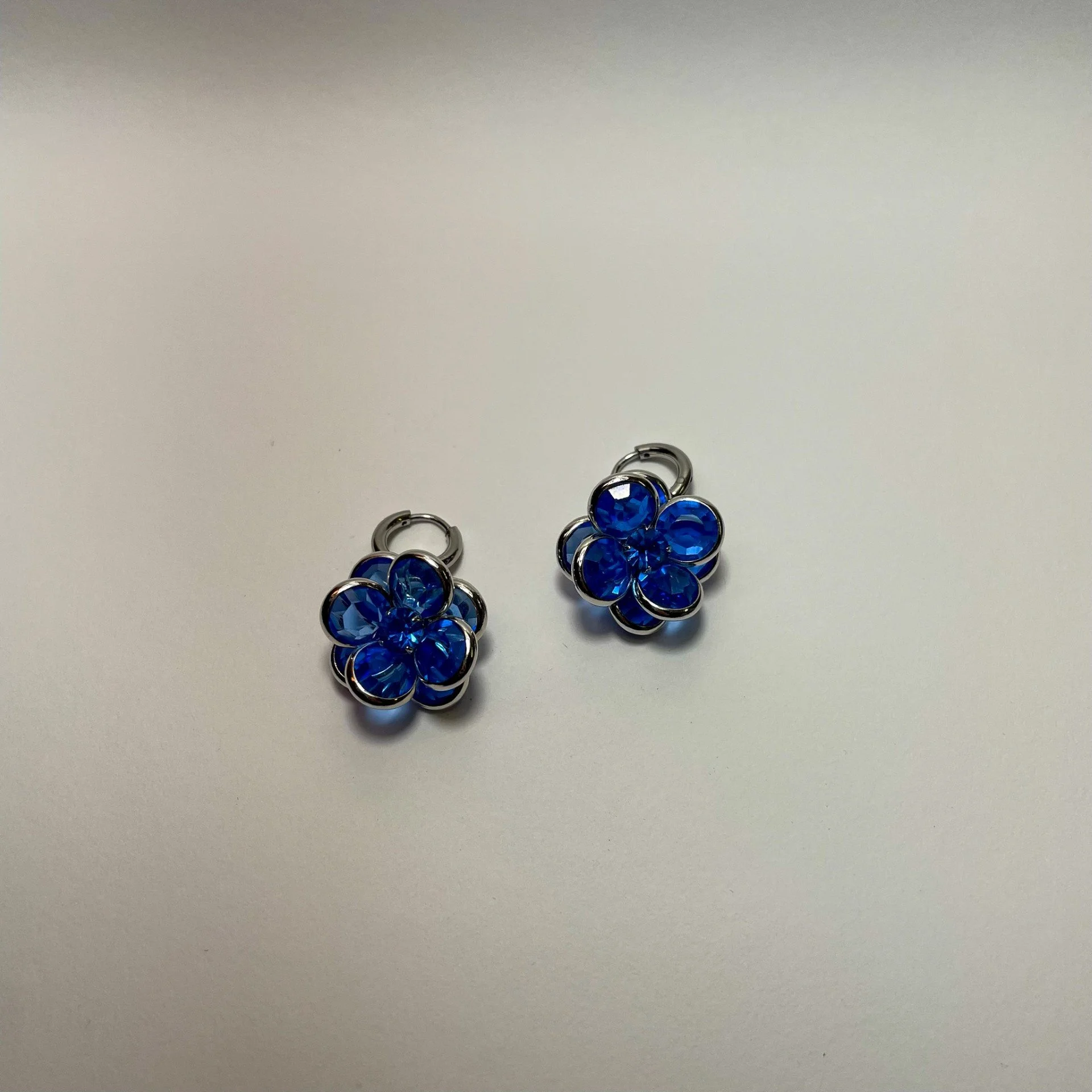 Blue flower earrings staged.jpeg