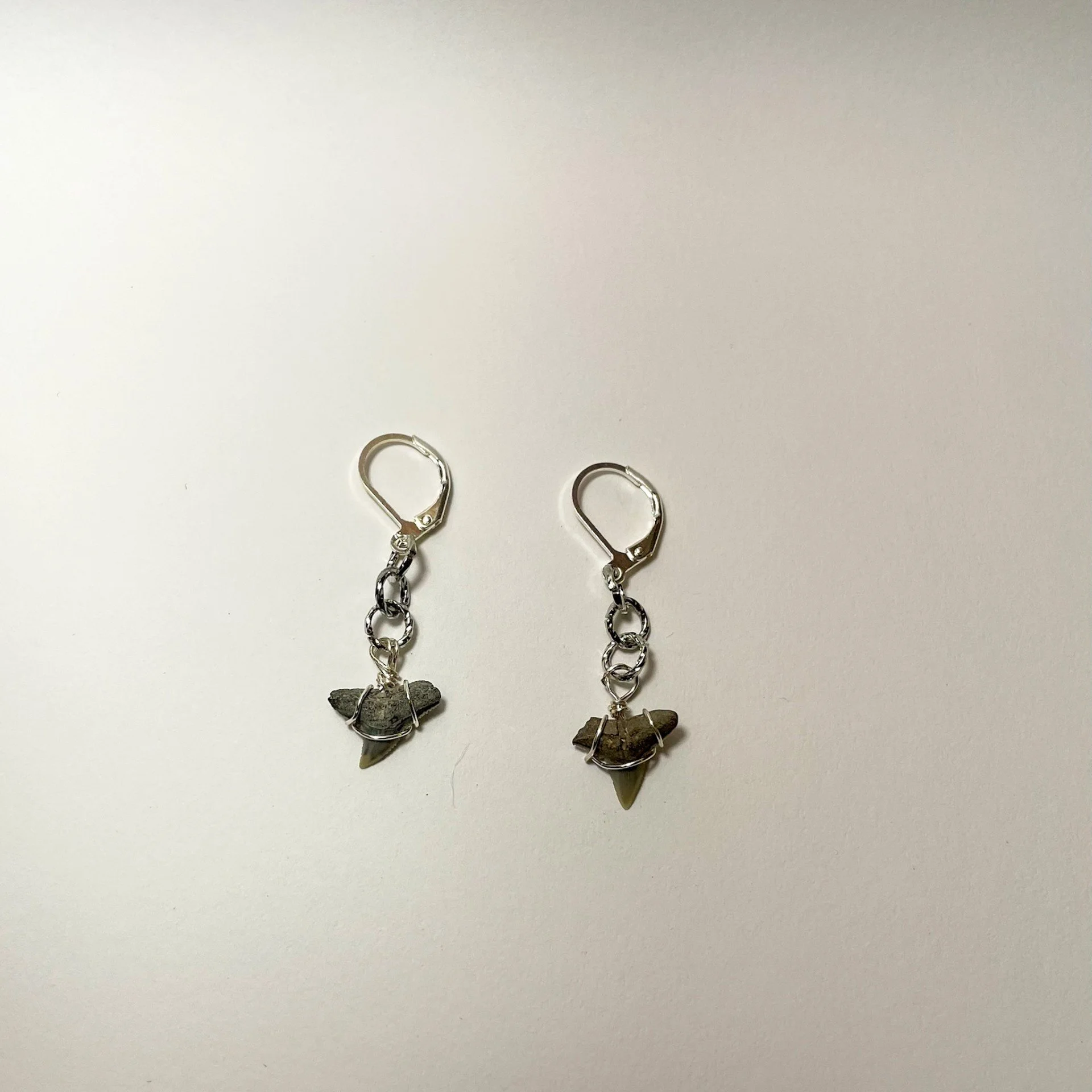 Short silver shark tooth dangle earrings staged.jpeg