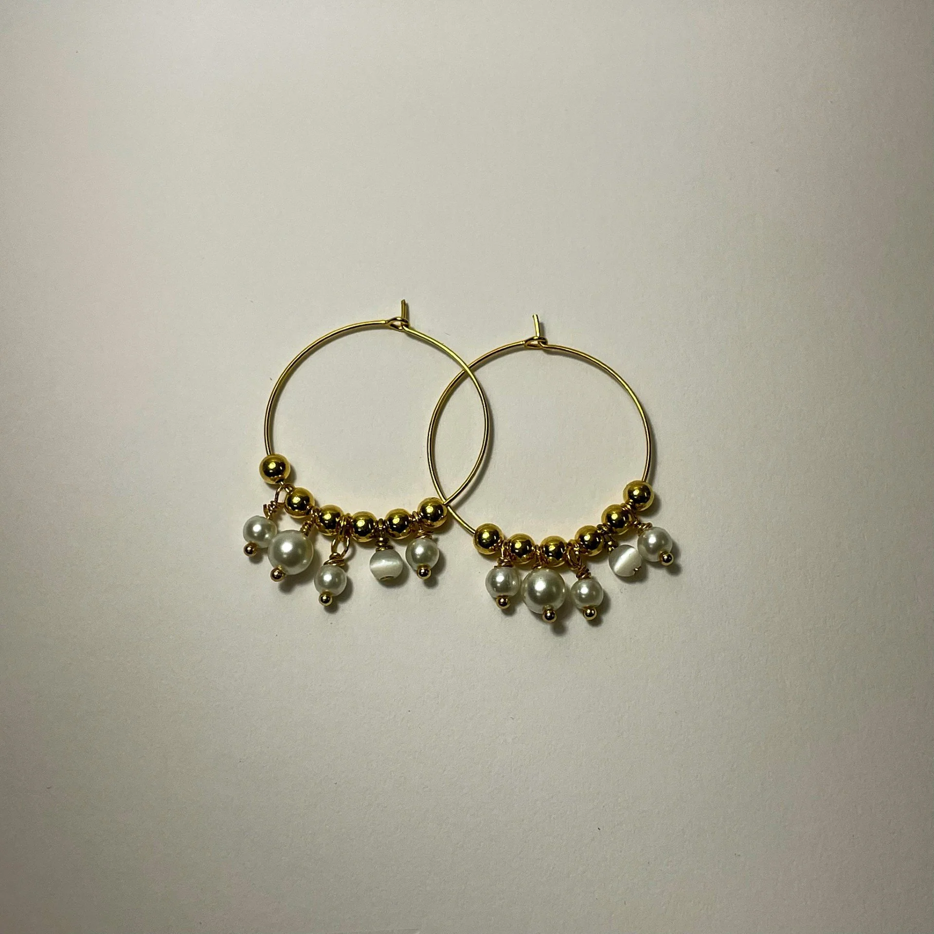 Gold bead and pearl gold hoop earrings staged.jpeg
