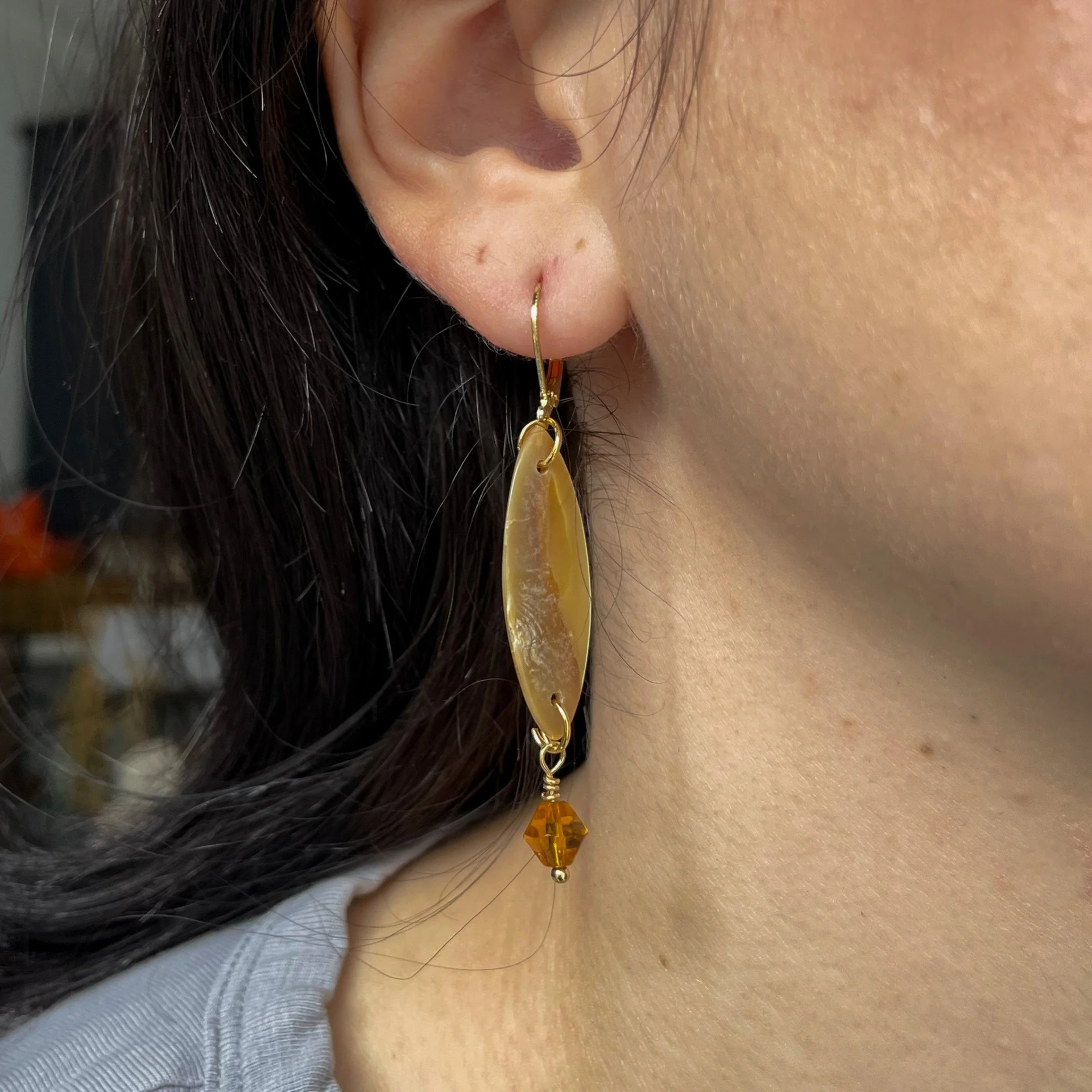 Gold Citrine and surfboard shaped earrings wearing.jpeg