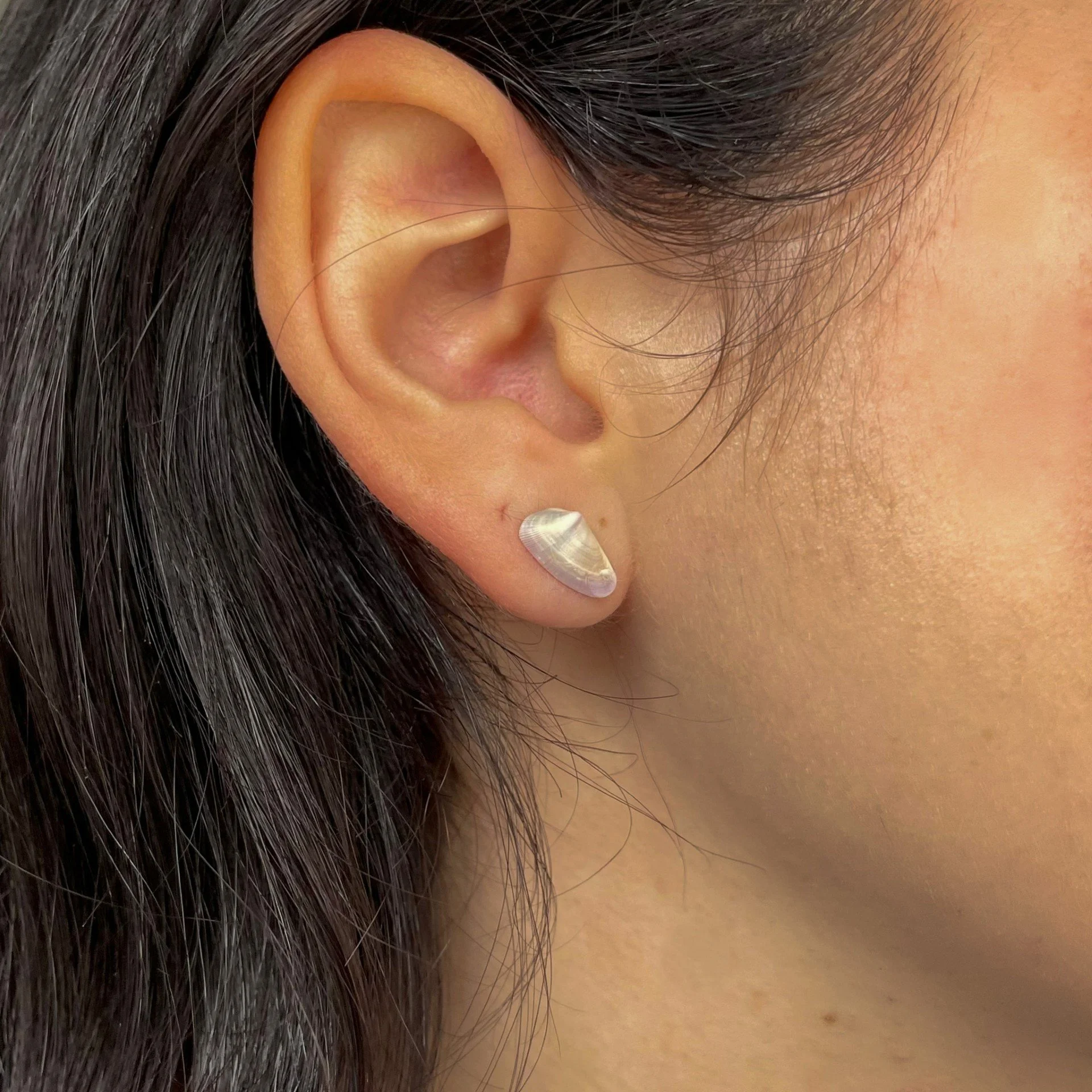 Small Grey shell earrings silver wearing.jpeg