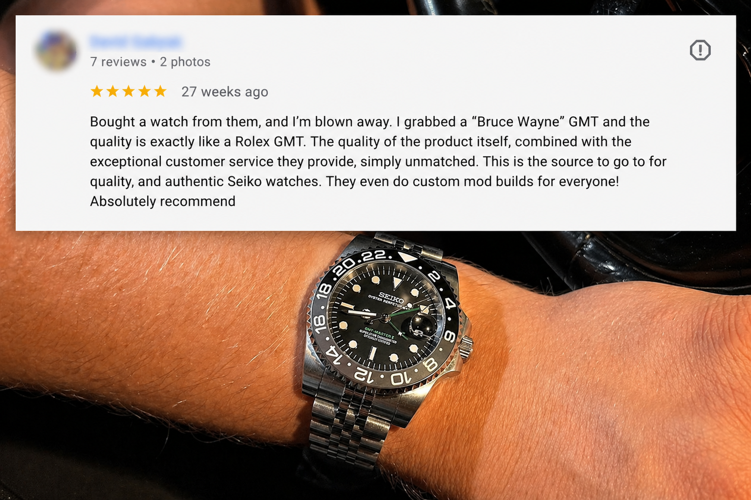A person's wrist wearing a Bruce Wayne GMT modded watch from Watch Mod