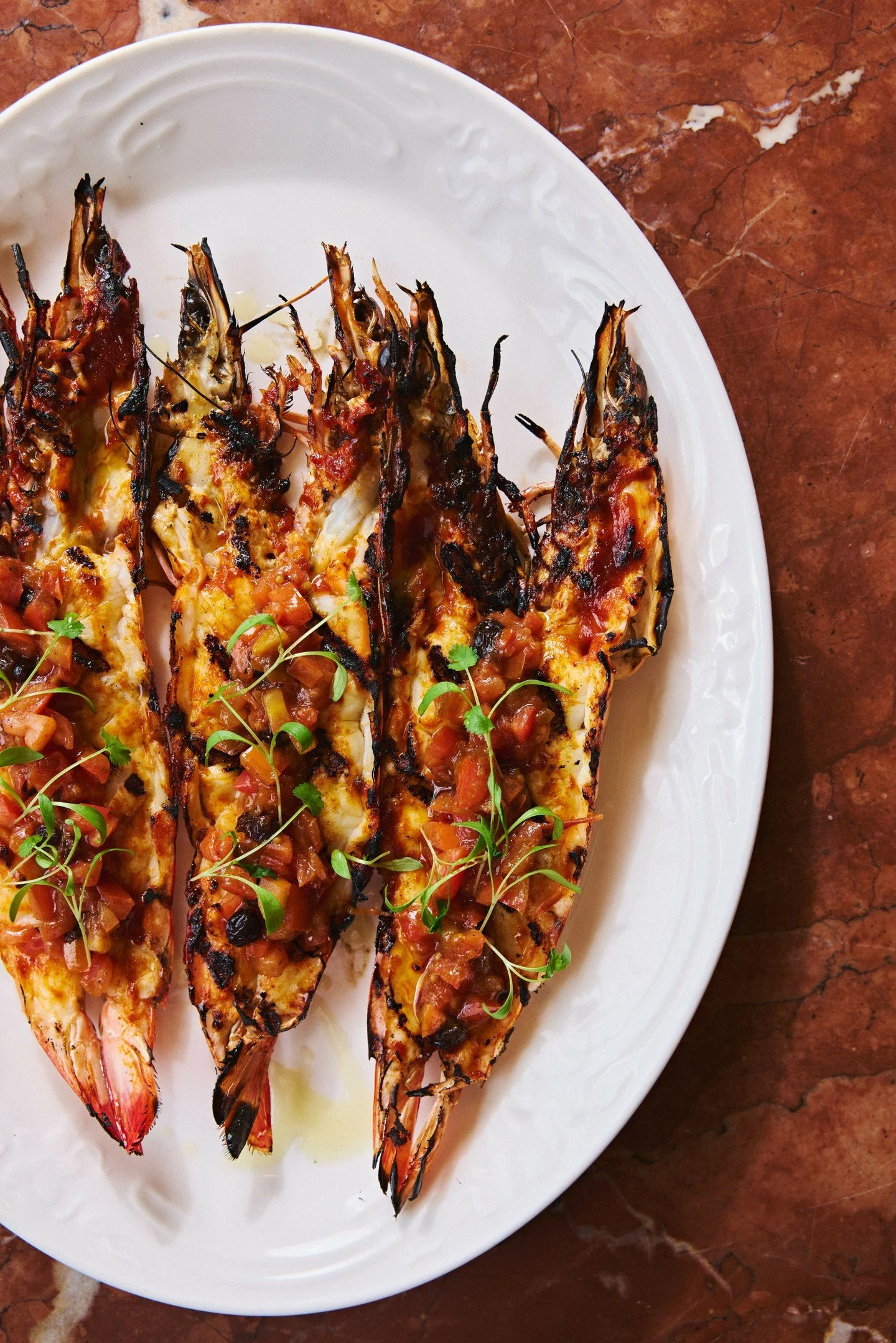 Our entr&eacute;e recommendation...

A buttery harissa with a gentle heat, balanced by the sweetness of prawns and a vibrant native bush tomato salsa.

Let our team guide you to the perfect wine pairing; an ideal start to a long lunch or an evening b