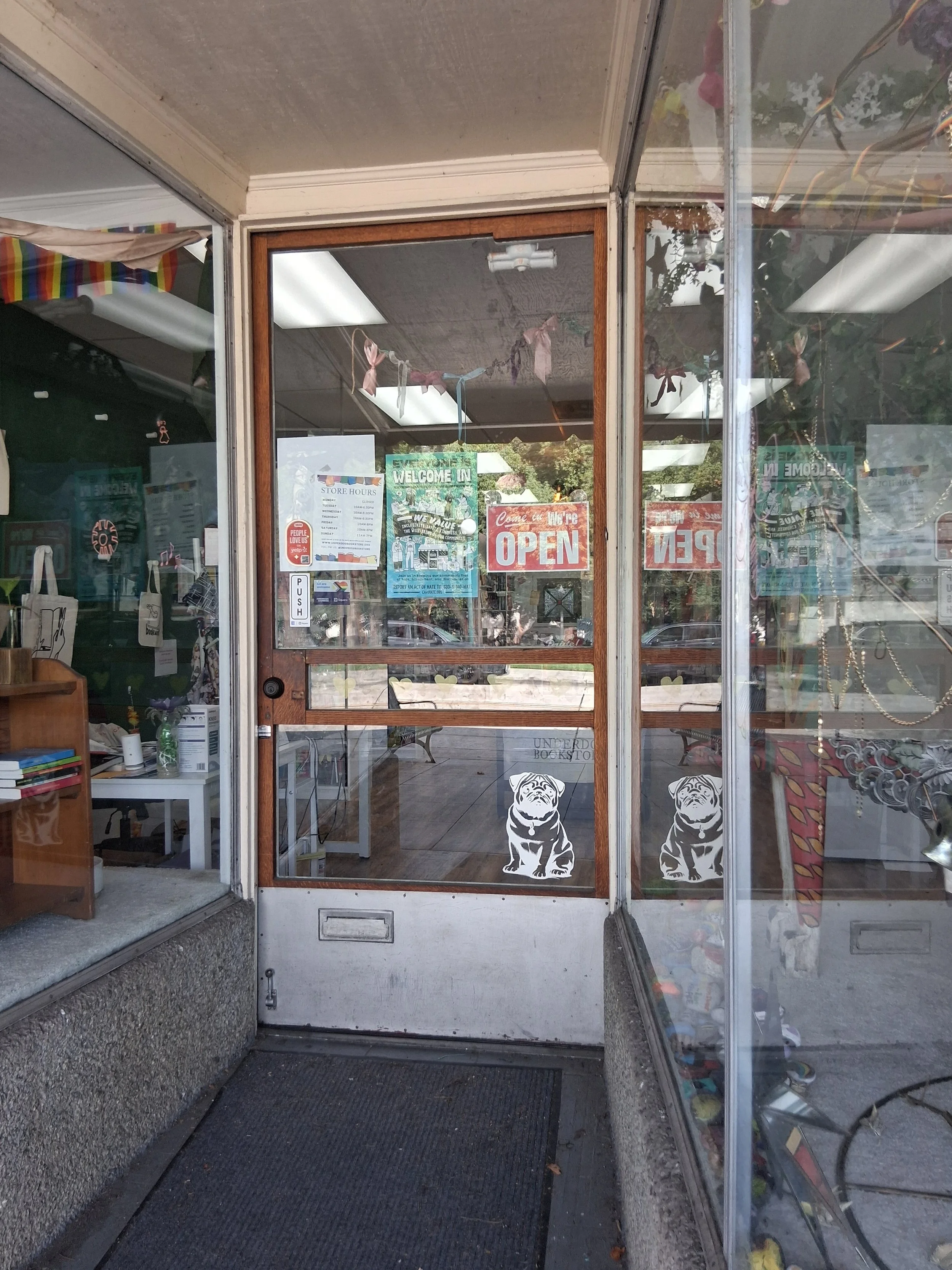 A picture of the front door of the store. the door is closed.