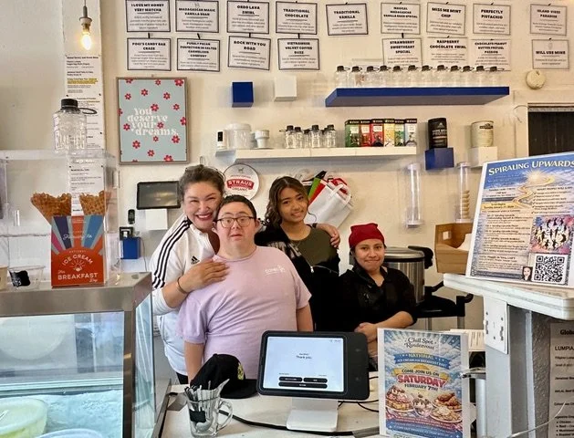 Maggie de Vera behind the counter with her staff.