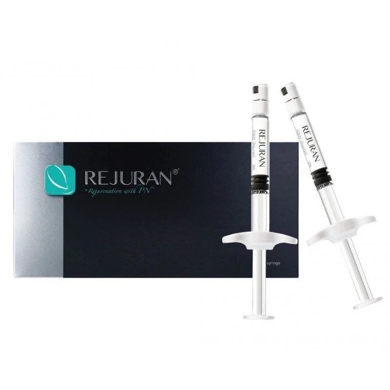 Two syringes placed next to a black and silver box labeled 'REJURAN' with a leaf logo, indicating a cosmetic or dermatological product.