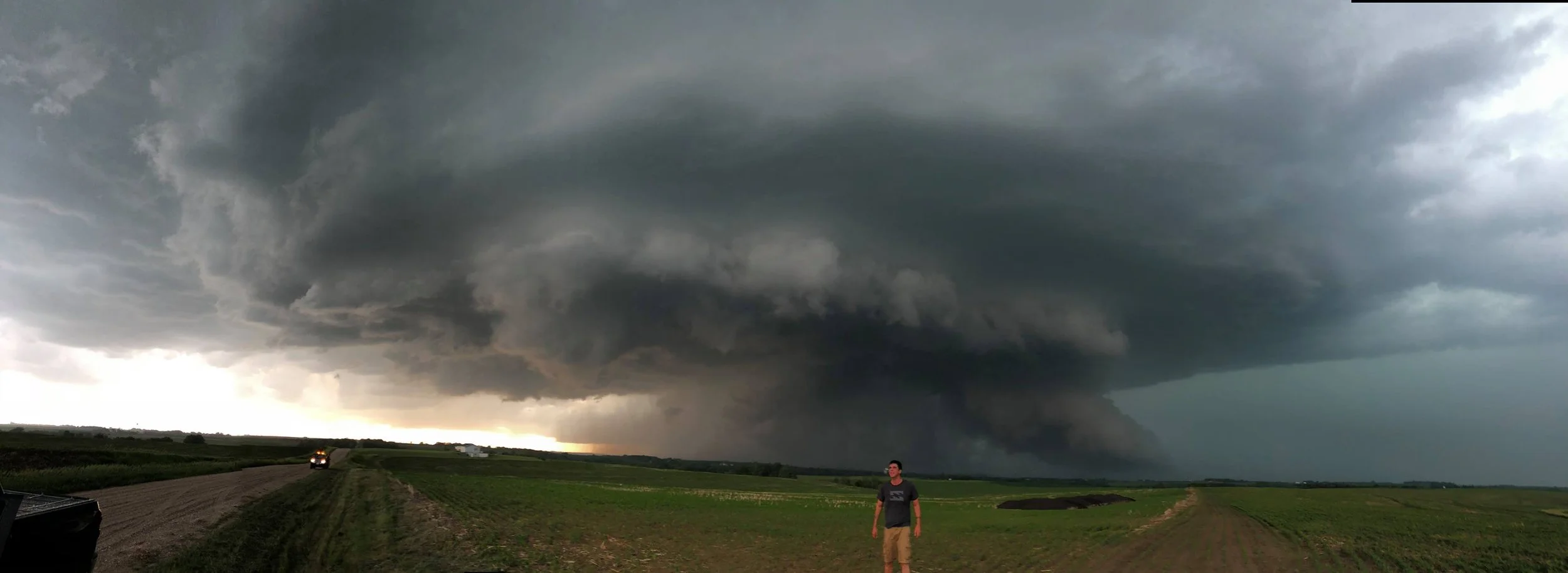 Storm Chaser Caleb Elliott standing in front of a tornado warned supercell thunderstorm (Thanks to James Wilson for taking to pic with my phone)