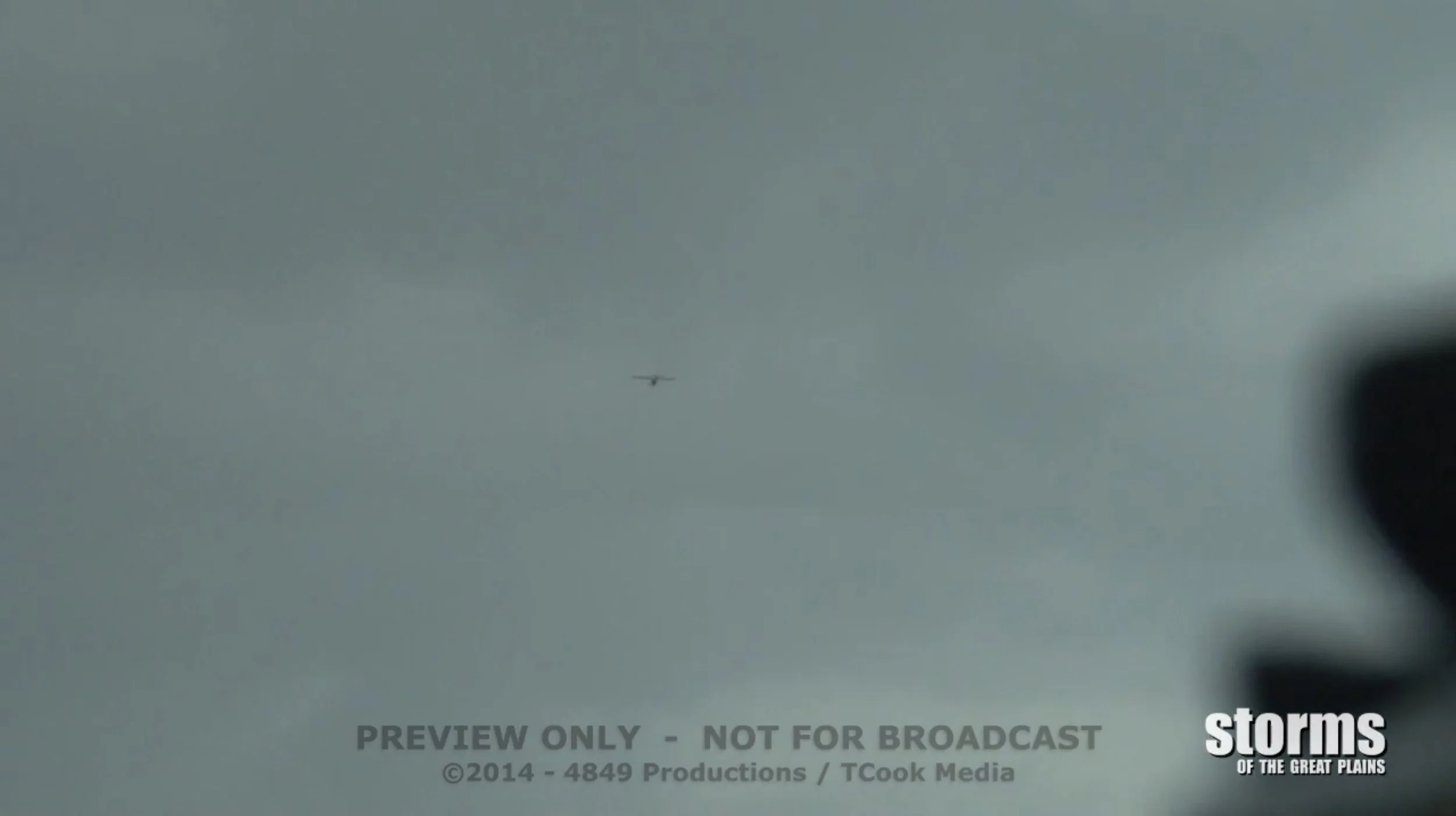 Storm chaser Caleb Elliott and Skip Talbot chasing a tornado warned supercell thunderstorm in a cessna 182 over Kansas in May 2012.  Looking up at Cessna flying towards supercell thunderstorm.