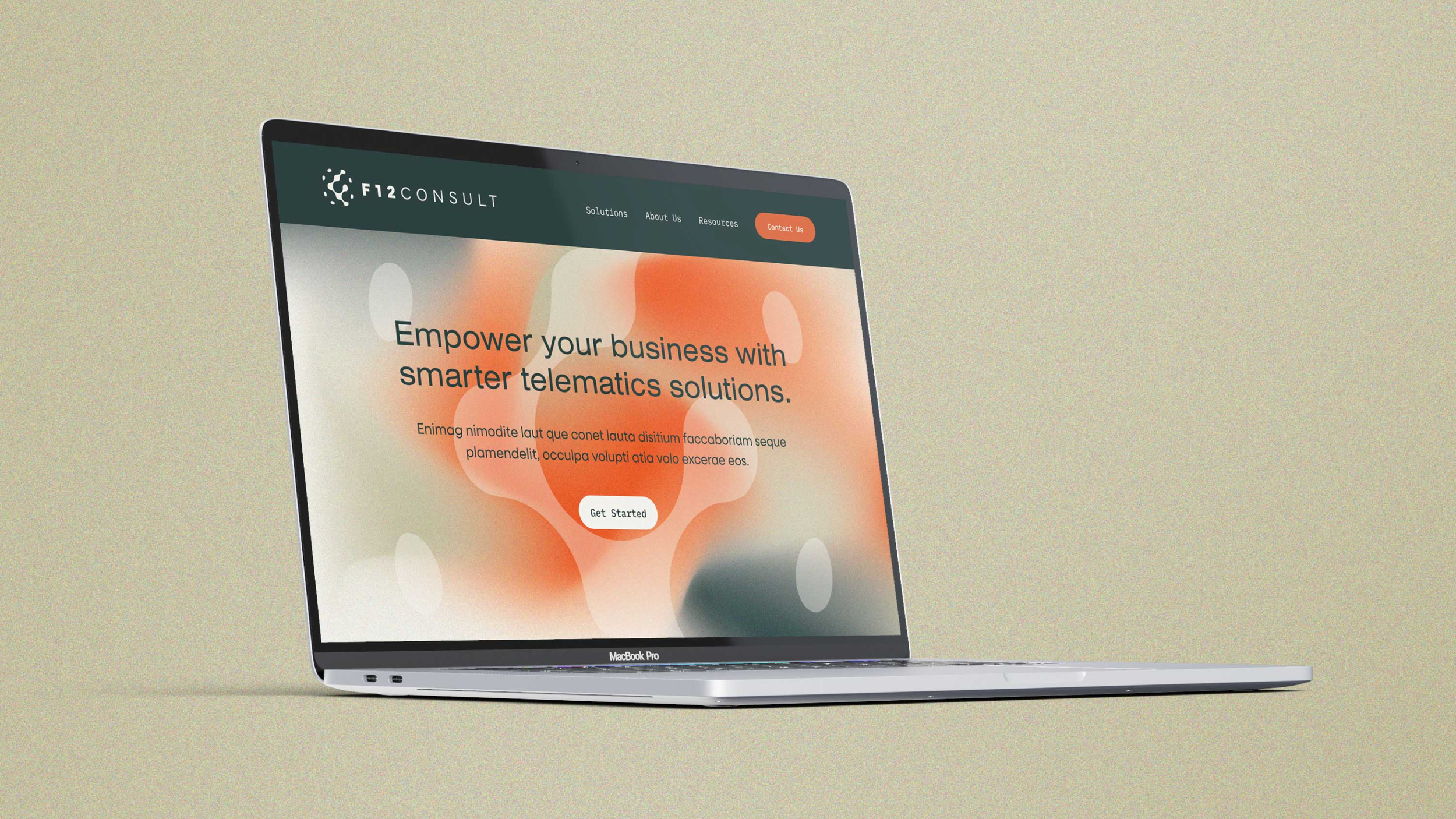 Open MacBook Pro displaying a website for F12Consult with a tagline about empowering businesses with smarter telematics solutions, featuring a 'Get Started' button on a blurry orange and beige background.