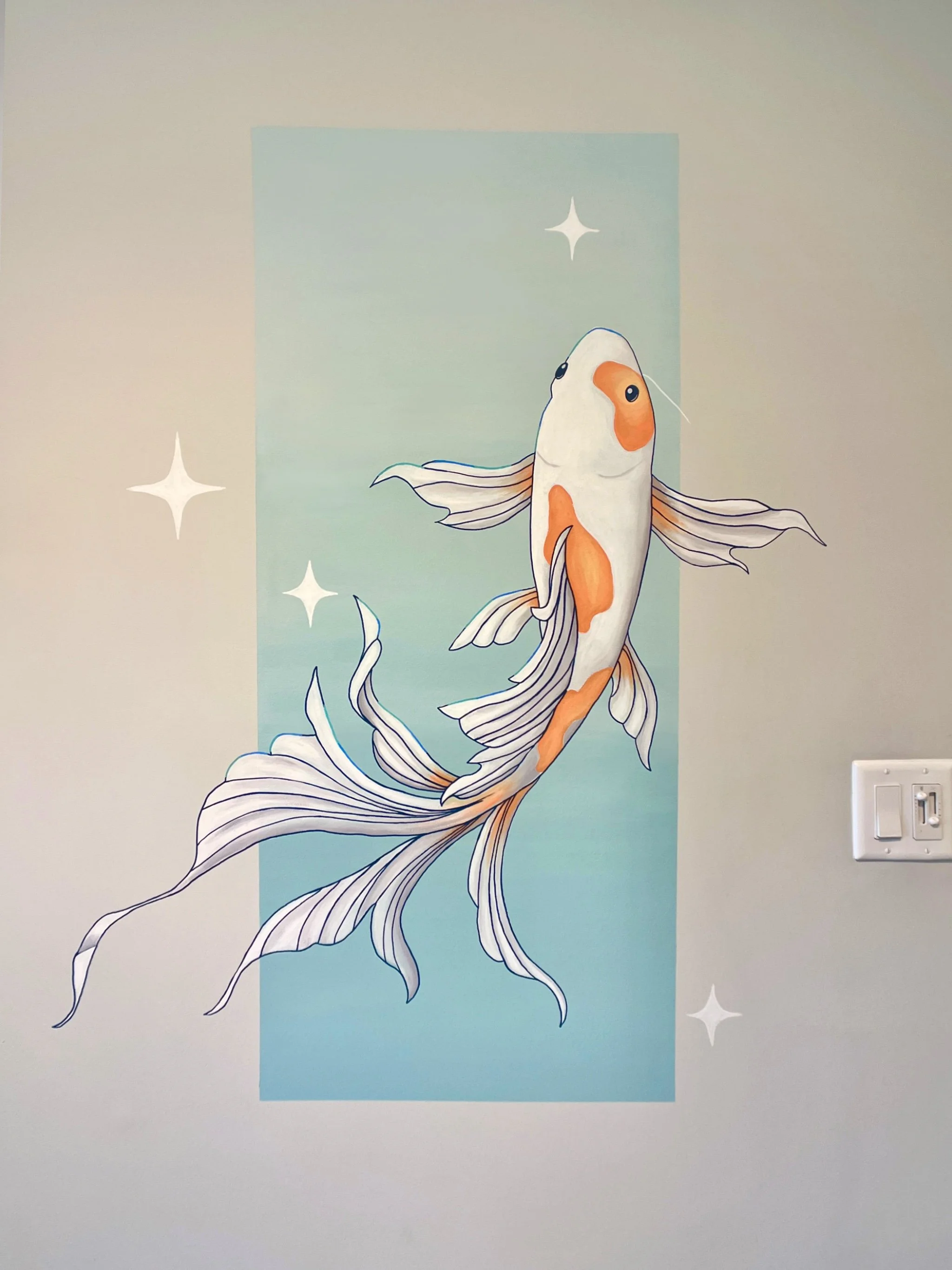 Wall mural of a koi fish with orange and white coloring, swimming against a blue gradient background with white star-like accents.