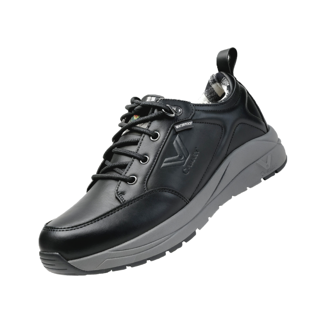 Men’s waterproof full-grain leather outdoor winter boots on rugged terrain in black