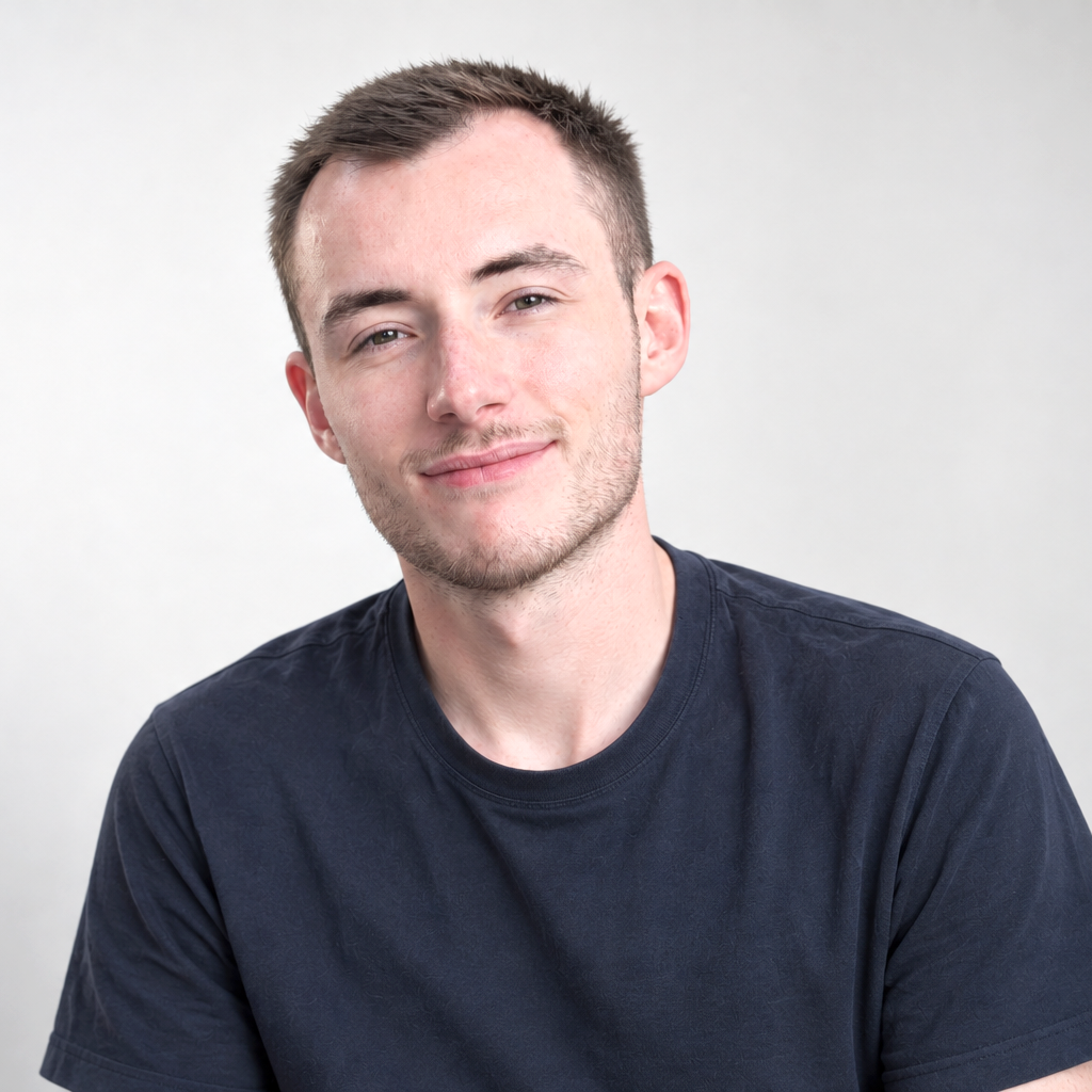 professional photograph of white man, short brown hair, wearing dark blue crew neck tshirt