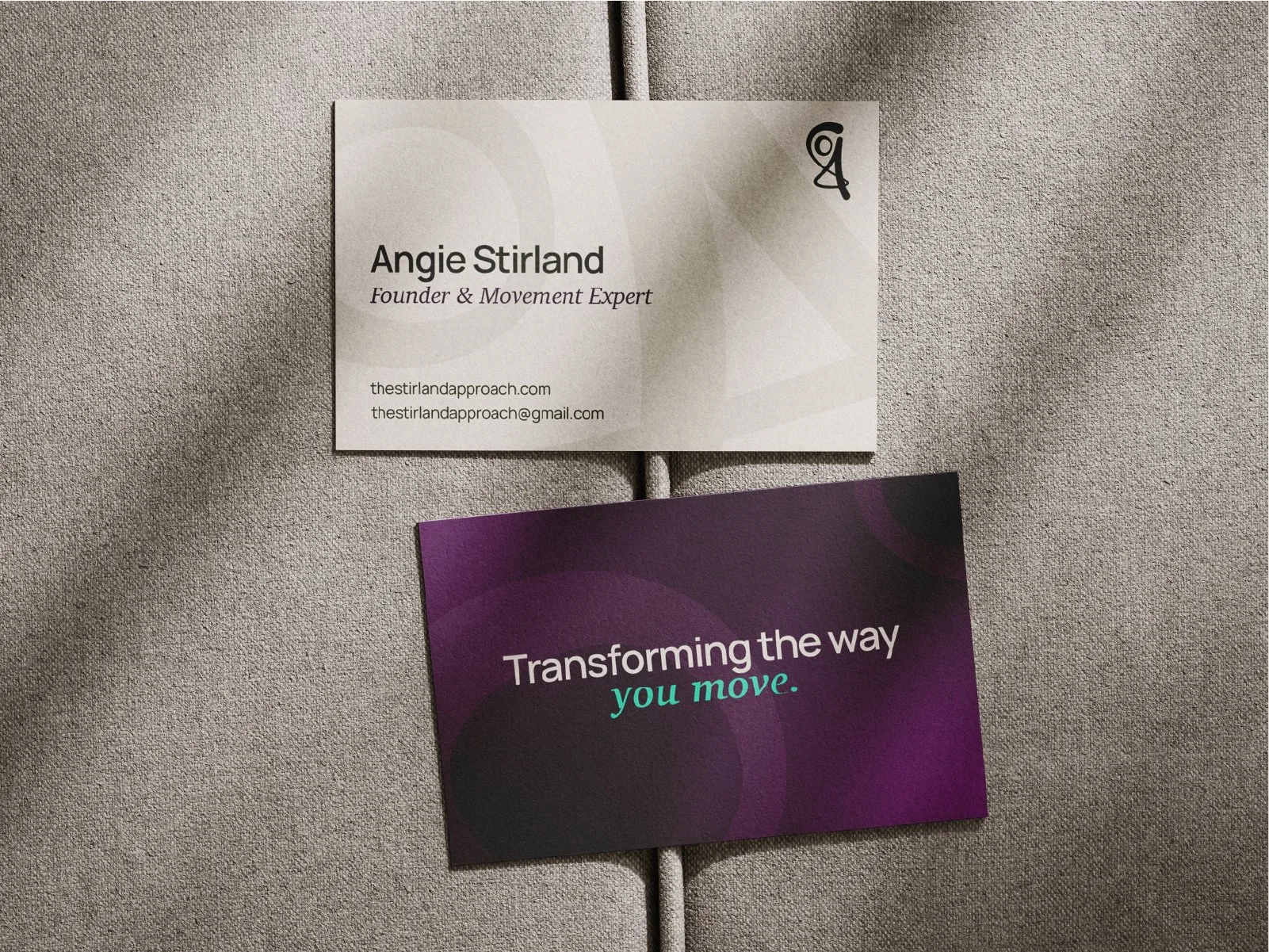 Cream and purple The Stirland Approach business cards on a sofa. Angie Stirland Founder on the card. Transforming the wave you move