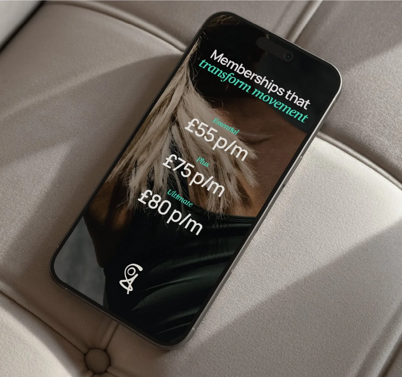 A mobile phone with prices listed, the phone placed on a sofa