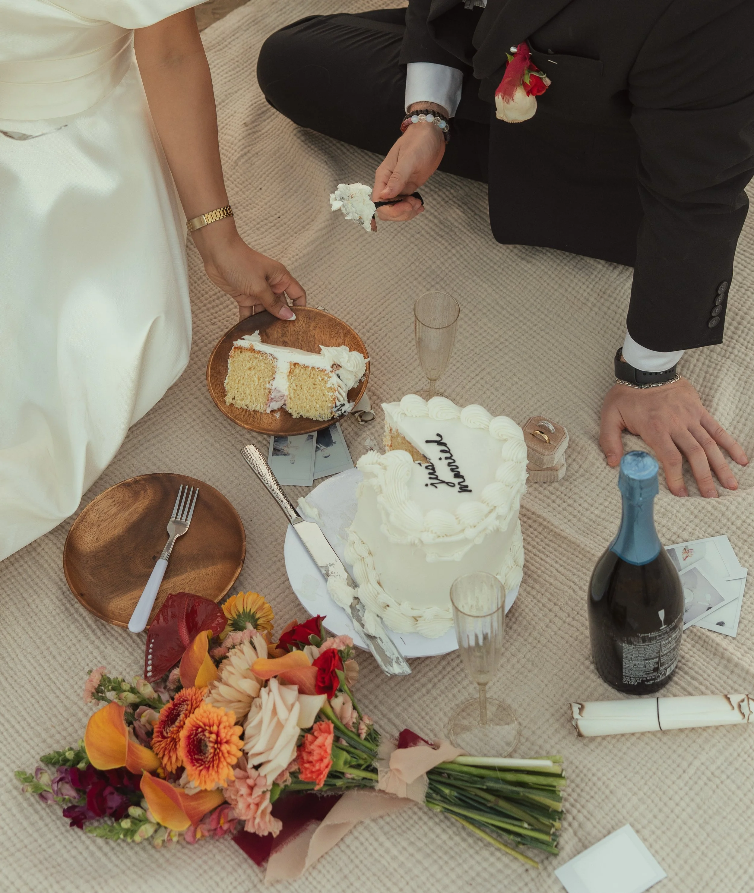 Elopement couple celebrating with cake