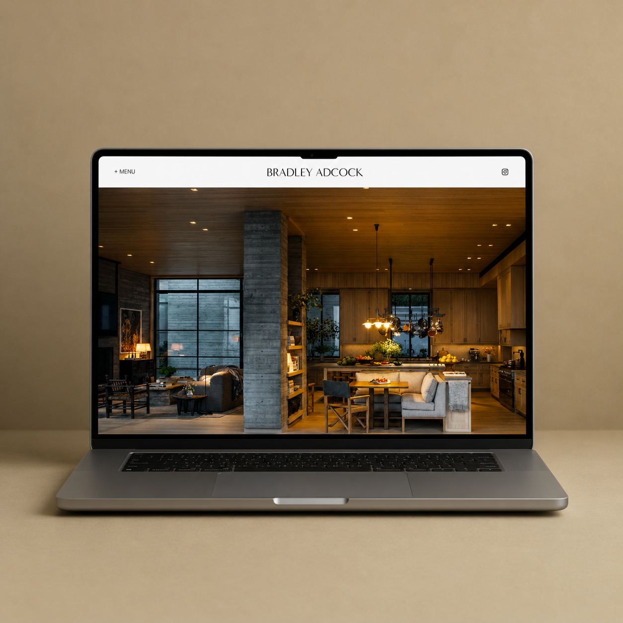 A desk with a laptop displaying interior design images, a beige mug, color swatches, an open sketchbook with a room plan, a pen, and a vase with green leaves. In the background, a wall with framed pictures and a basket on the right side.