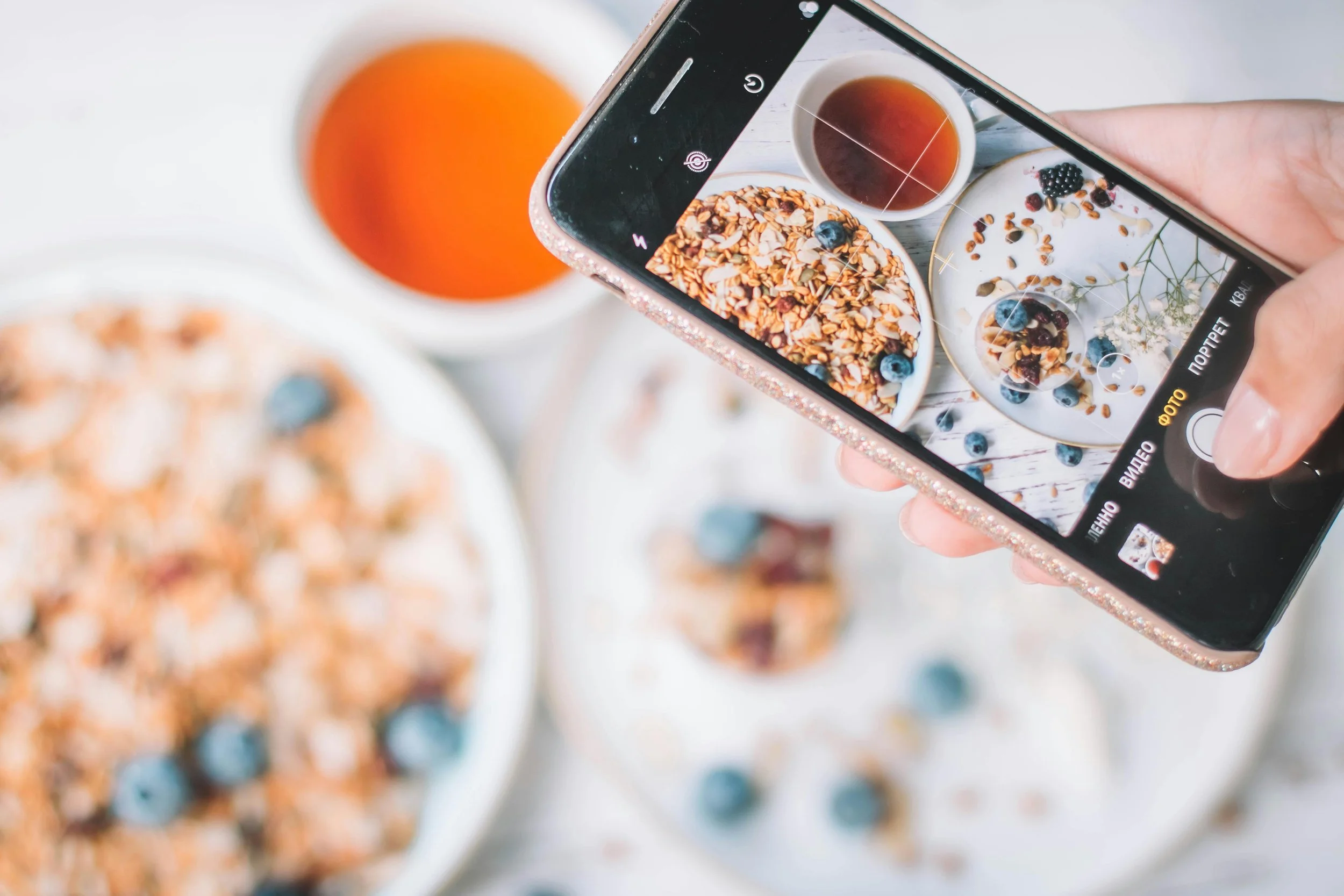 Image of a person taking a photo of their food with a smartphone