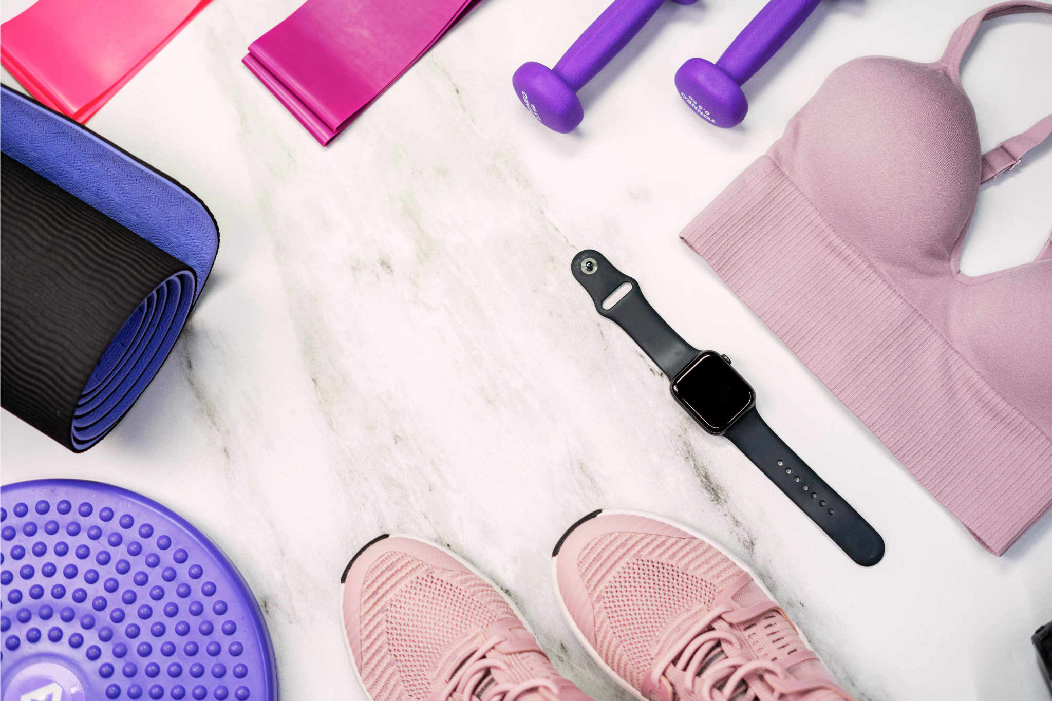 Women's fitness gear laid out on floor.
