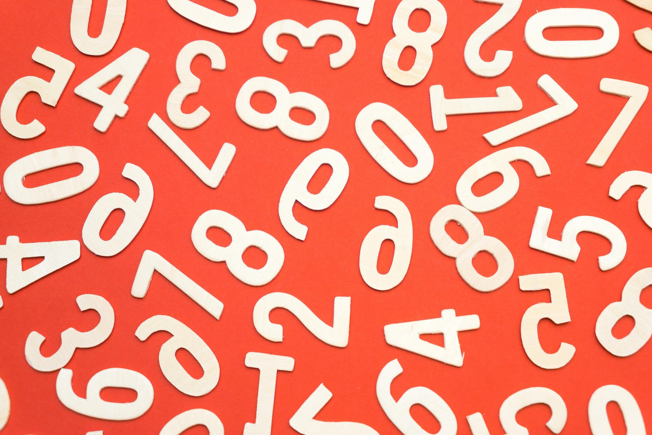 White numbers scattered across a red background