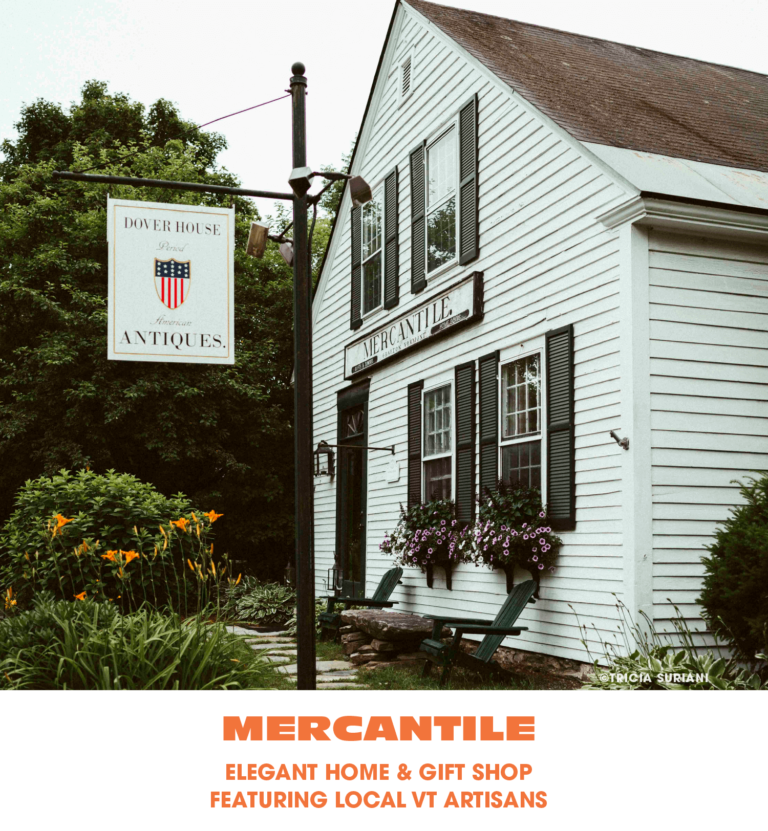 A white, two-story historic building with black shutters and flower boxes, sign reading 'Mercantile,' outside a vintage shop, with a lawn and garden in the foreground, and a hanging sign for Dover House Antiques.