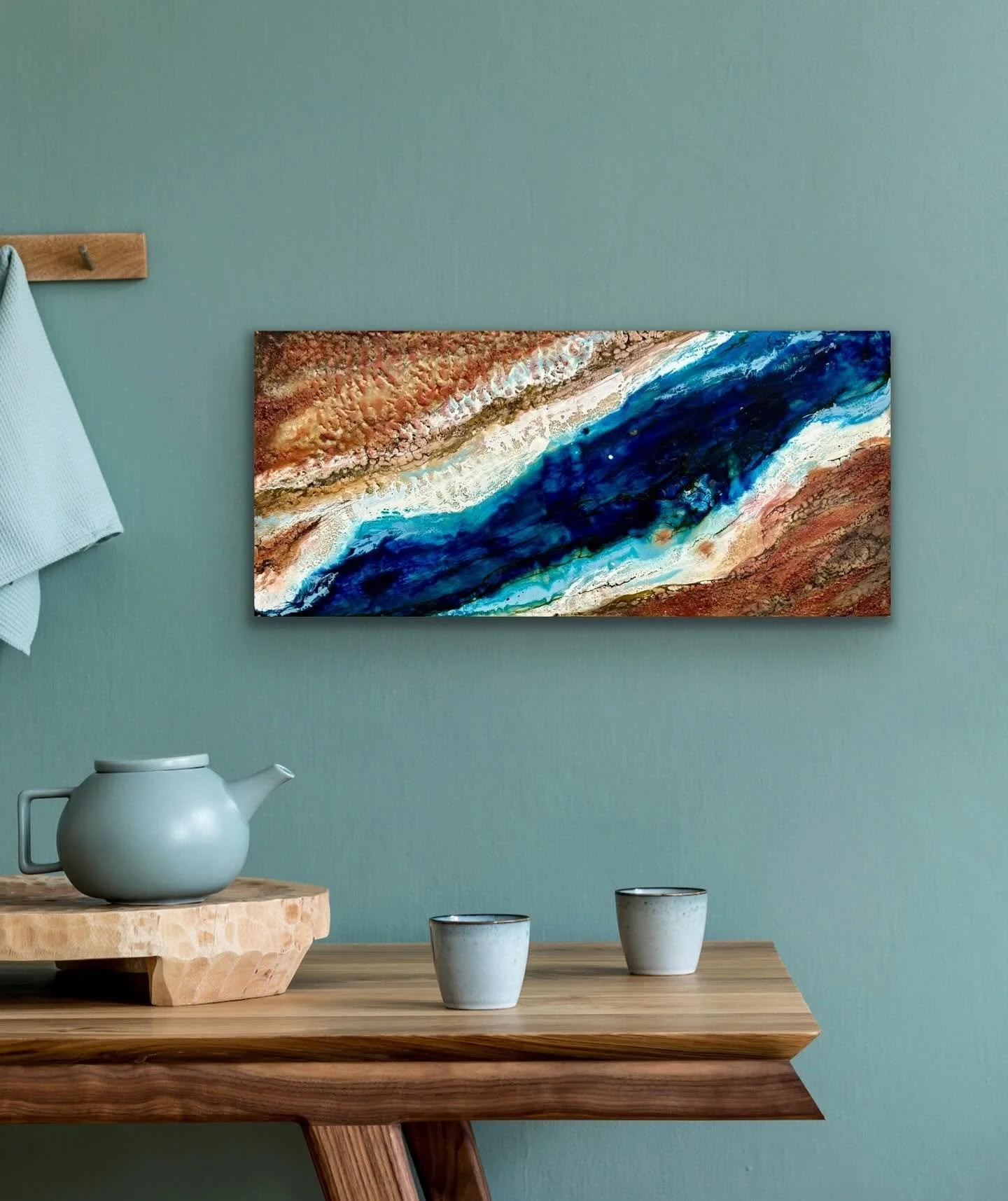 Horizontal encaustic painting by Emily Scott in rust and deep blue, wave-like composition, Beaufort SC original art