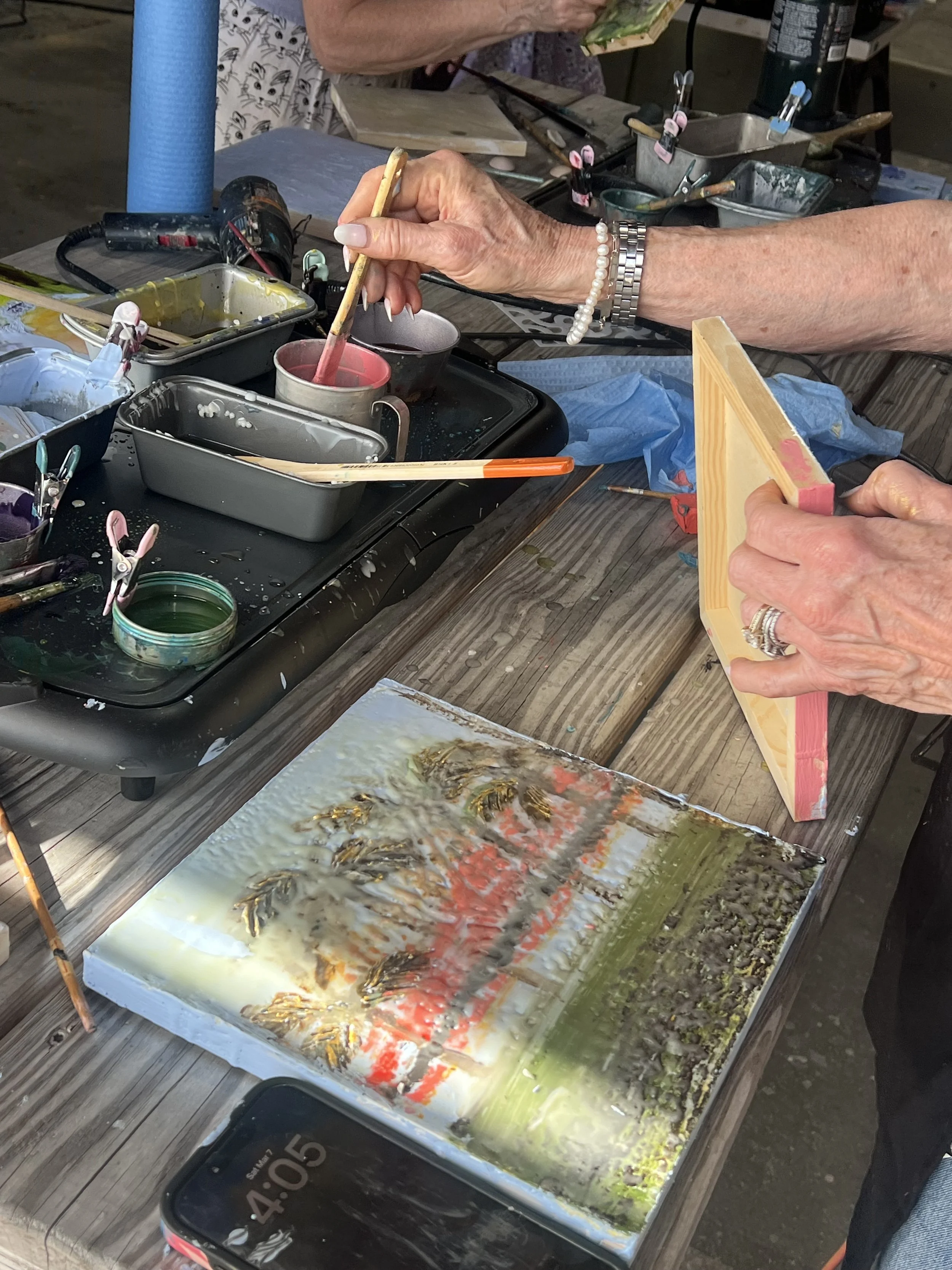Artist working with layered photo transfer and encaustic medium during an advanced workshop with Emily Scott in Beaufort SC