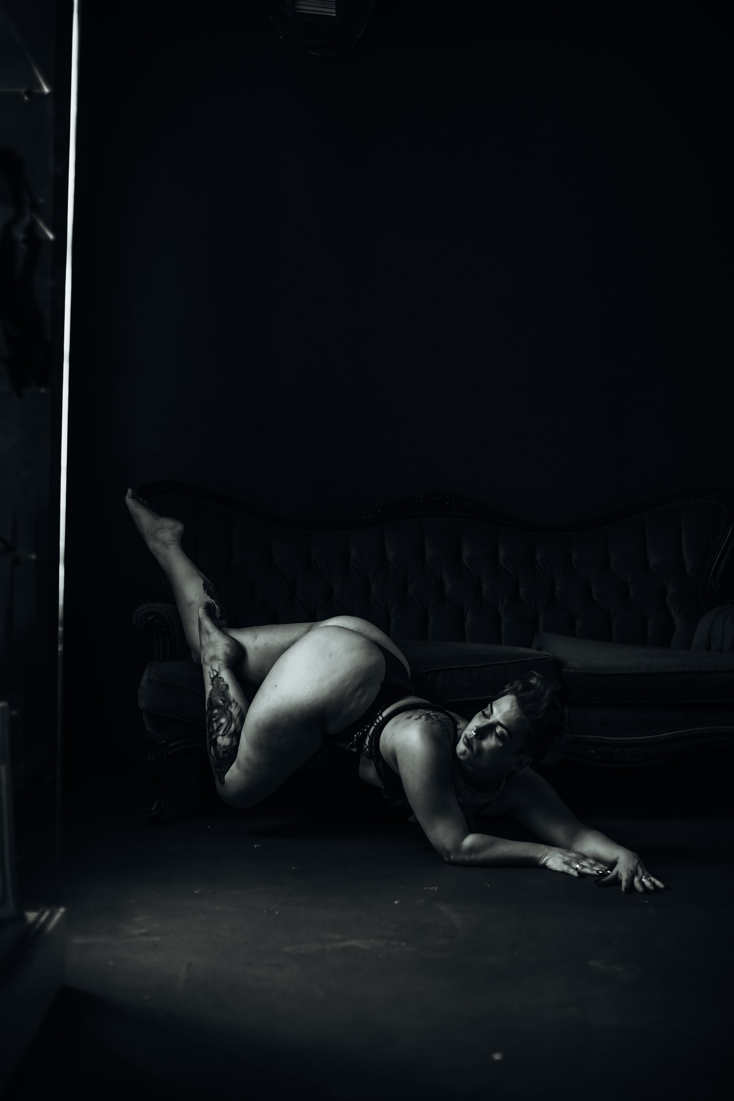 woman sliding off sofa looking at window fine art photographer Auburn Alabama