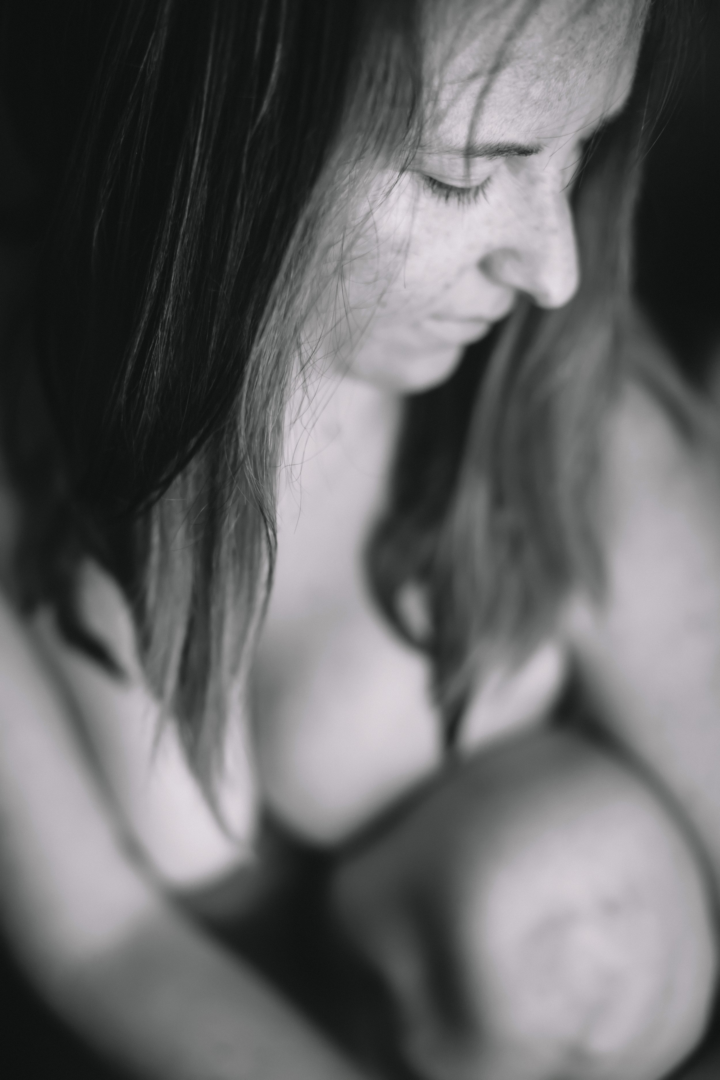 Close up nude boudoir shoot of woman looking away Auburn Alabama