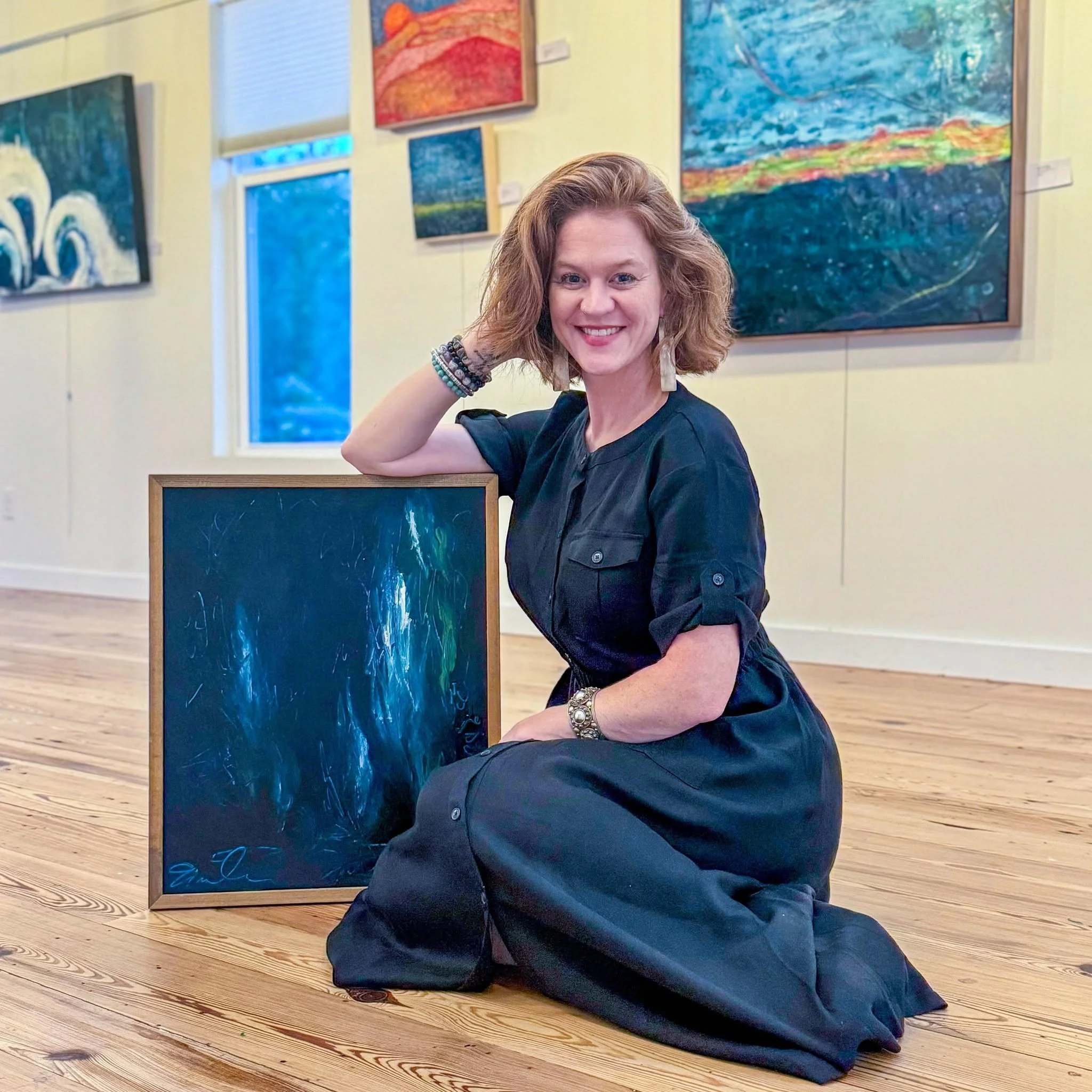 Emily Scott with one of her original encaustic paintings on display at a gallery exhibition in South Carolina