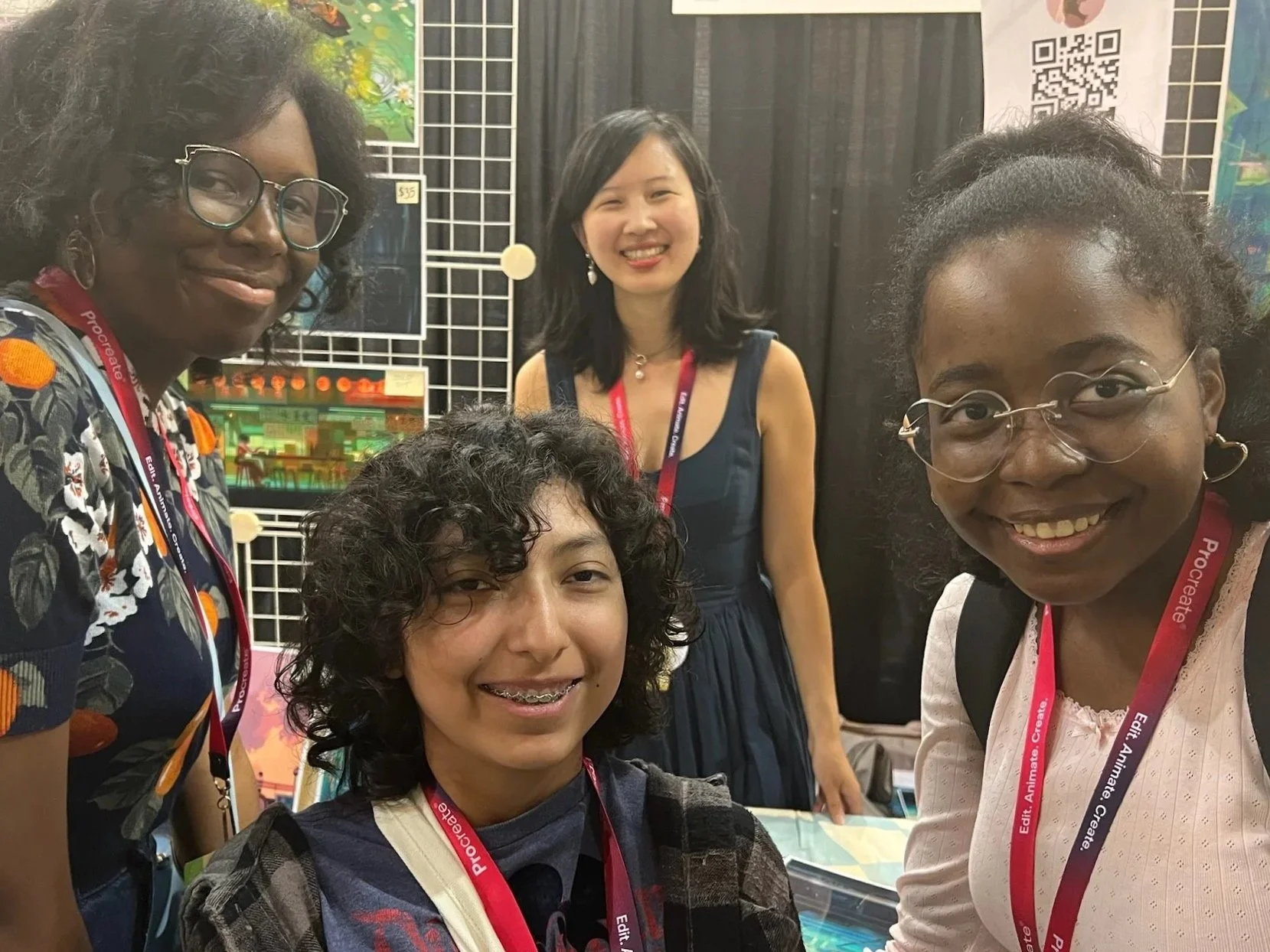 A picture of Mena, Payton, and their friend Juliet, taking a photo with artist Kat Tsai in LightBox Expo’s artist alley.