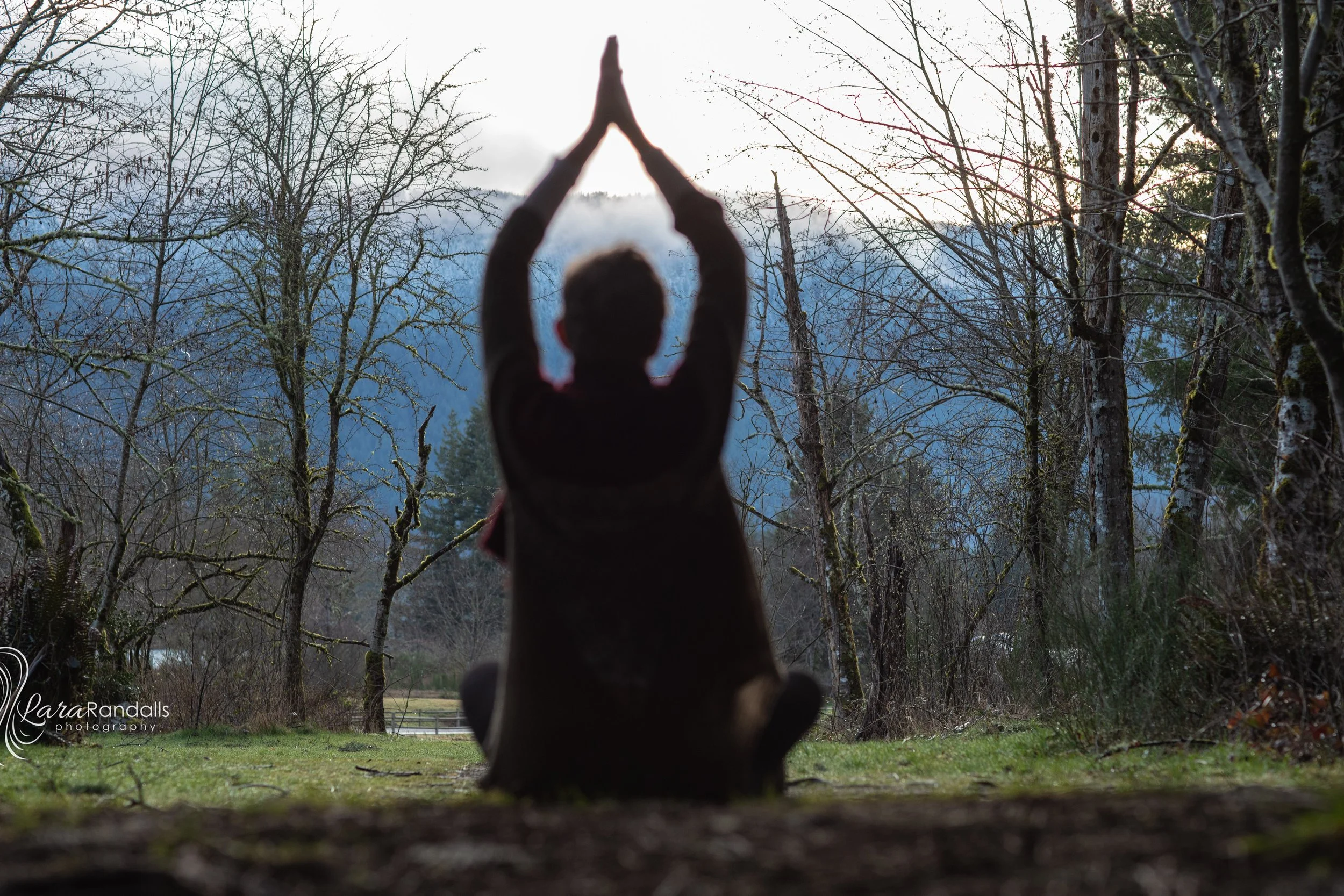 shadow of person sitting in meditation and prayer