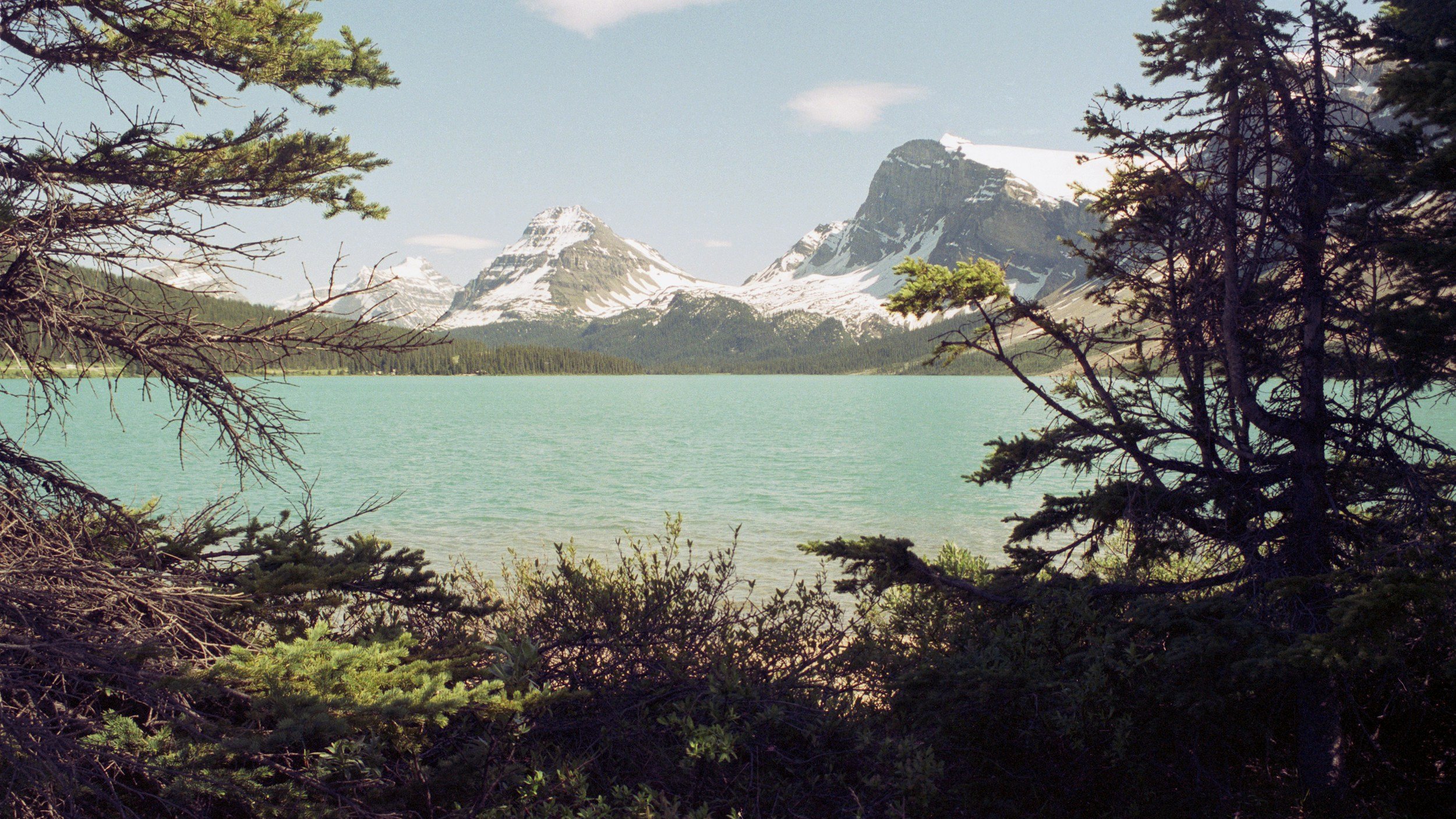 snow capped mountain on lake