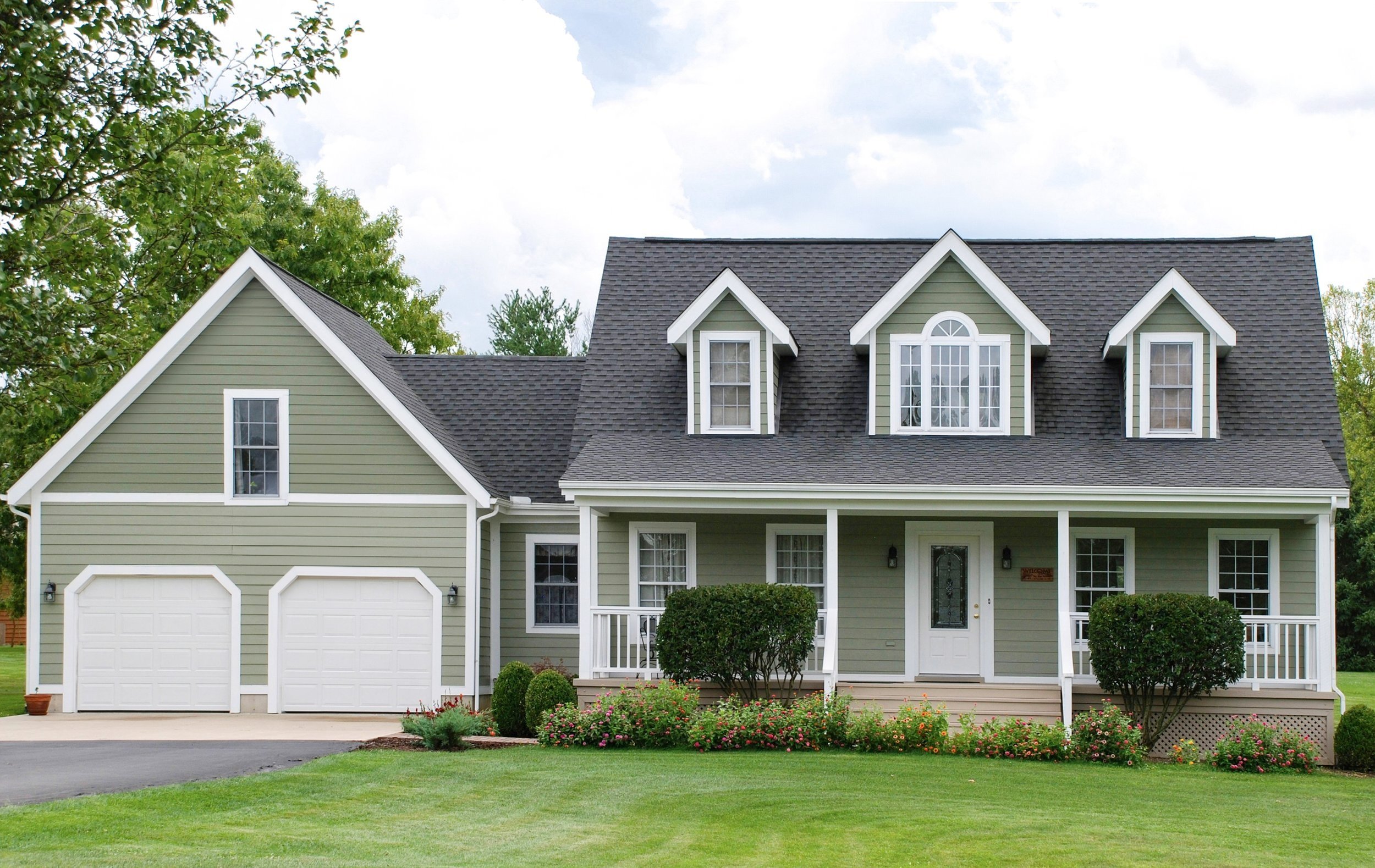 Green house with grey shingled roof