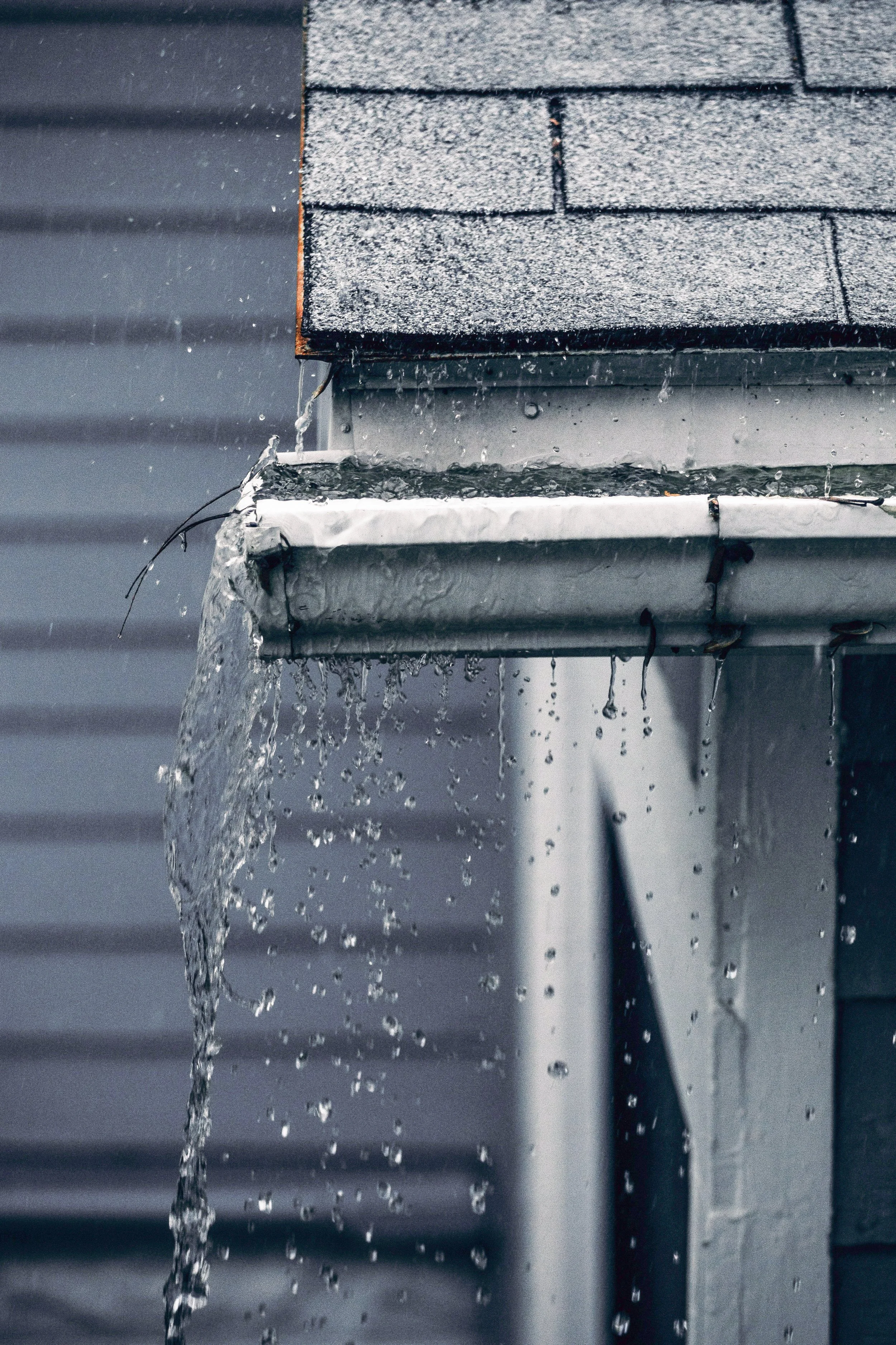 Broken gutter with splashing rain