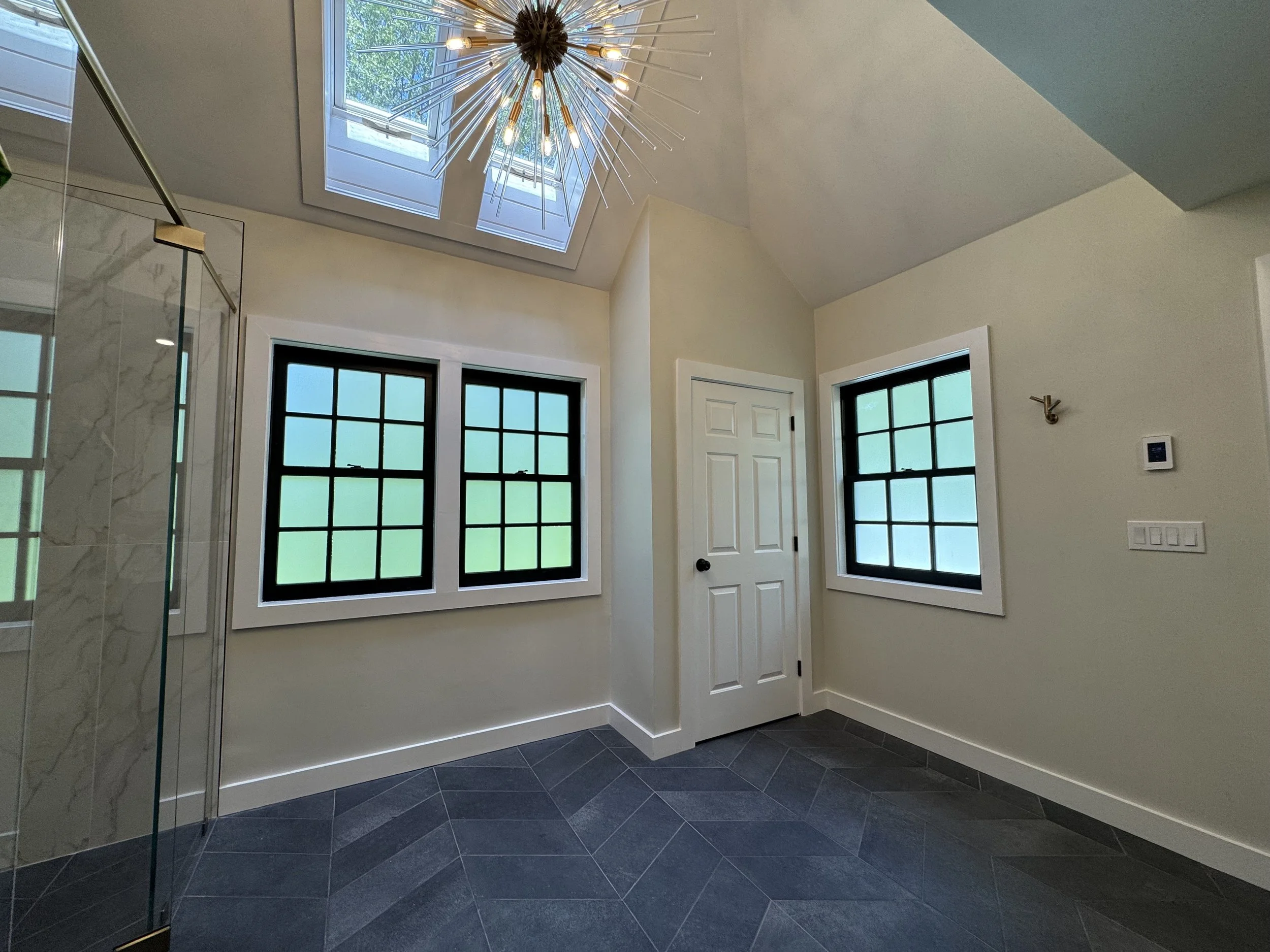Bathroom window with a frosted film design, enhancing privacy and adding a decorative touch.