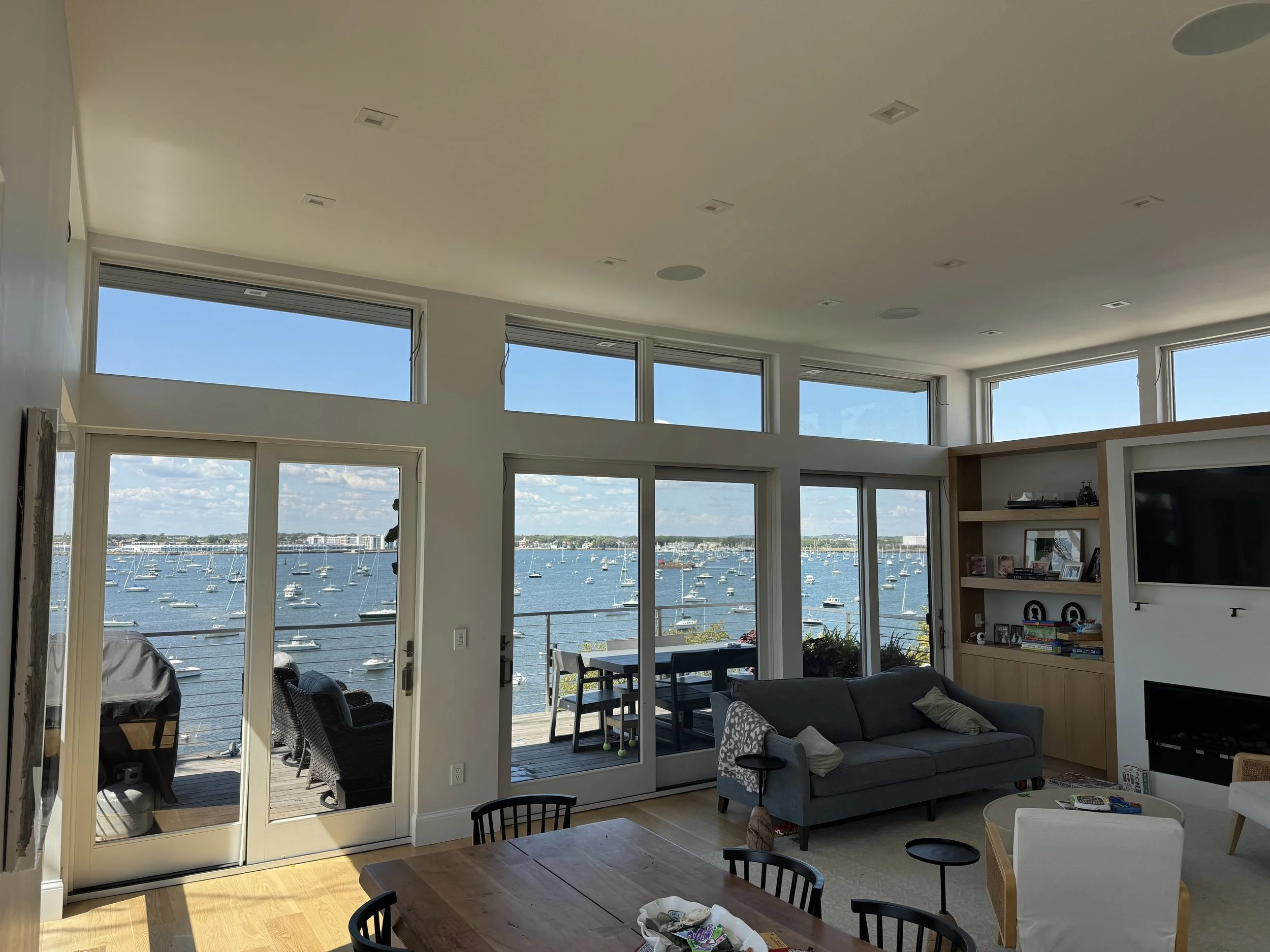 Residential window tinting with professional home window film installation, protecting interiors from UV rays and glare while keeping natural light and ocean views.