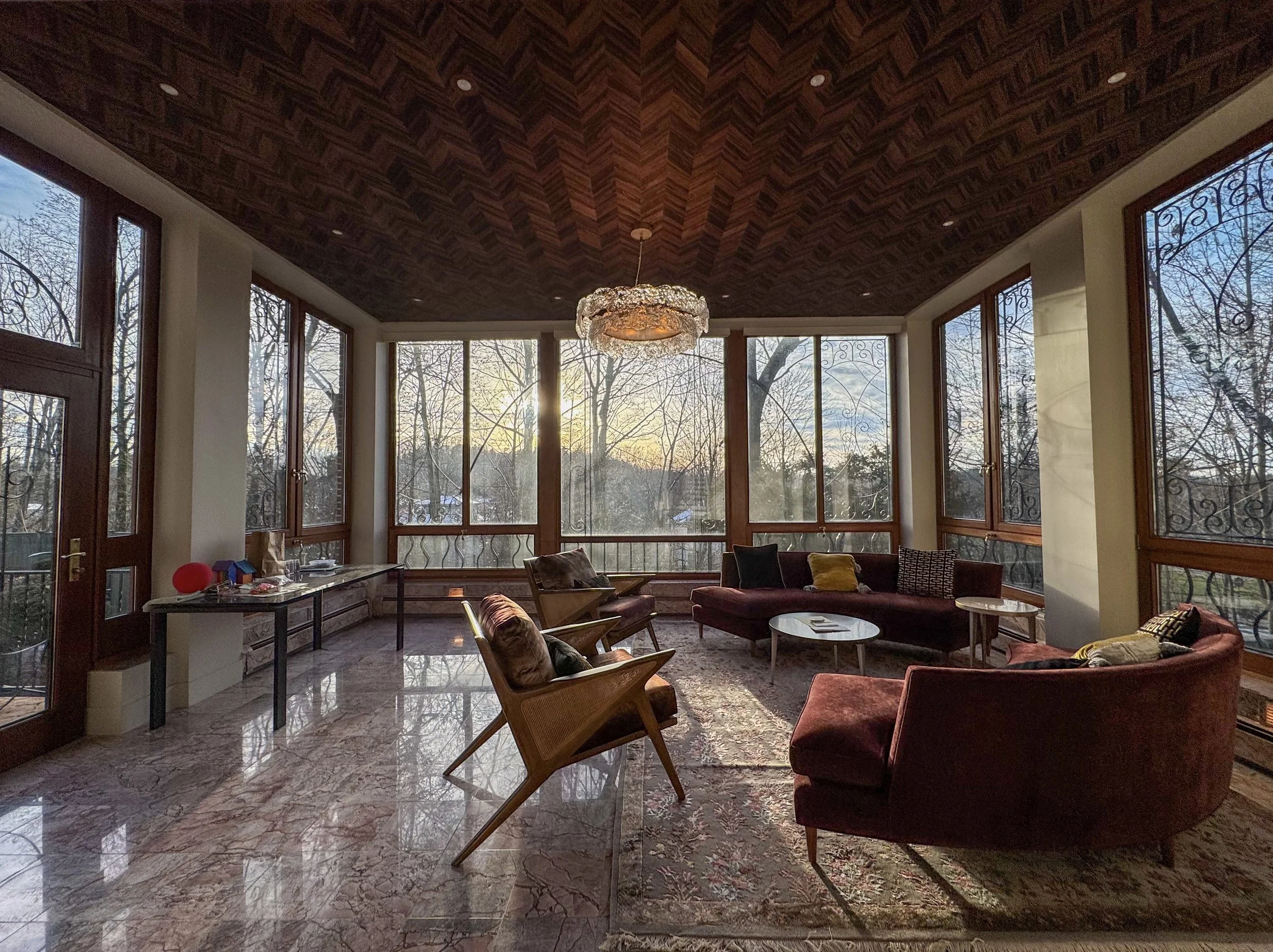 Sunroom with tinted windows allowing natural light in while maintaining privacy from neighbors.
