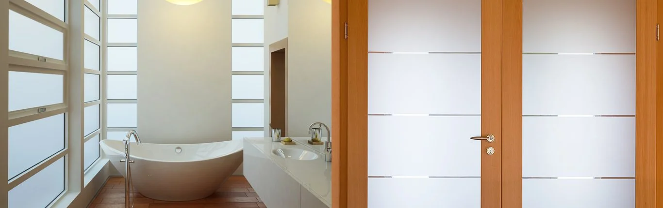 Bathroom window with a frosted film design, enhancing privacy and adding a decorative touch.