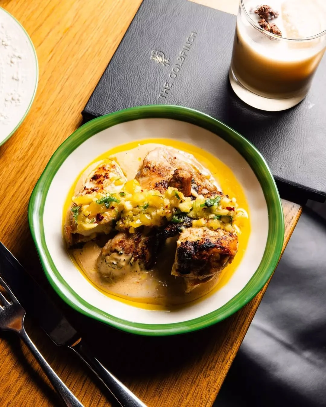 Our Half Roast Chicken: pineapple-rum-jerk marinated spring chicken with smoked mango &amp; green onion salsa, bread &amp; cream sauce, roasted honey almonds, and a bright Champagne vinaigrette with orange oil.