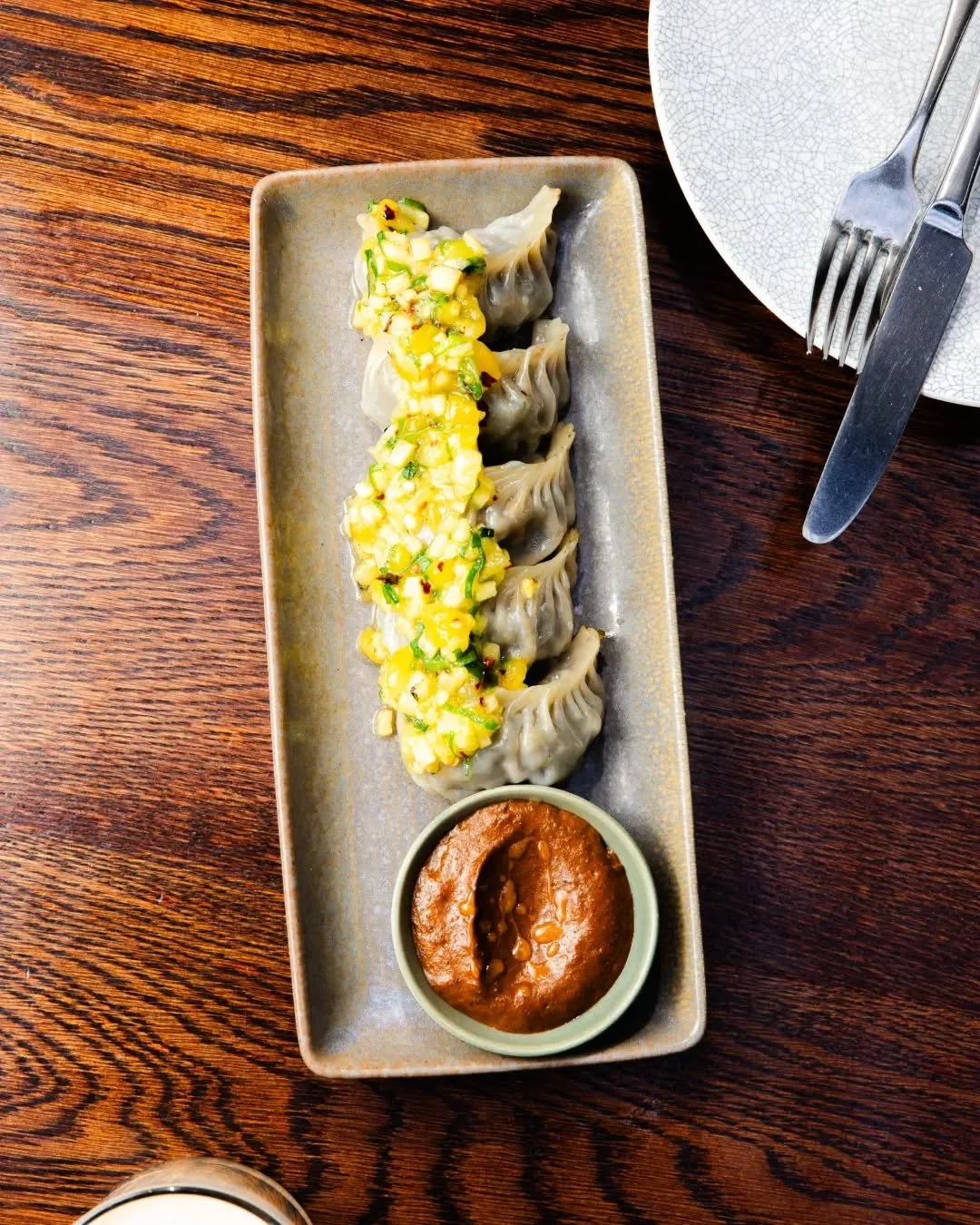 Pouch-perfect. 🥟✨

Our Beggar&rsquo;s Purse Dumplings feature a rich, earthy filling of mushroom, corn, leek, and scallion, beautifully balanced with a bright, sweet mango salsa and a deeply savoury roasted sesame &amp; tomato chutney.

Drop by The 