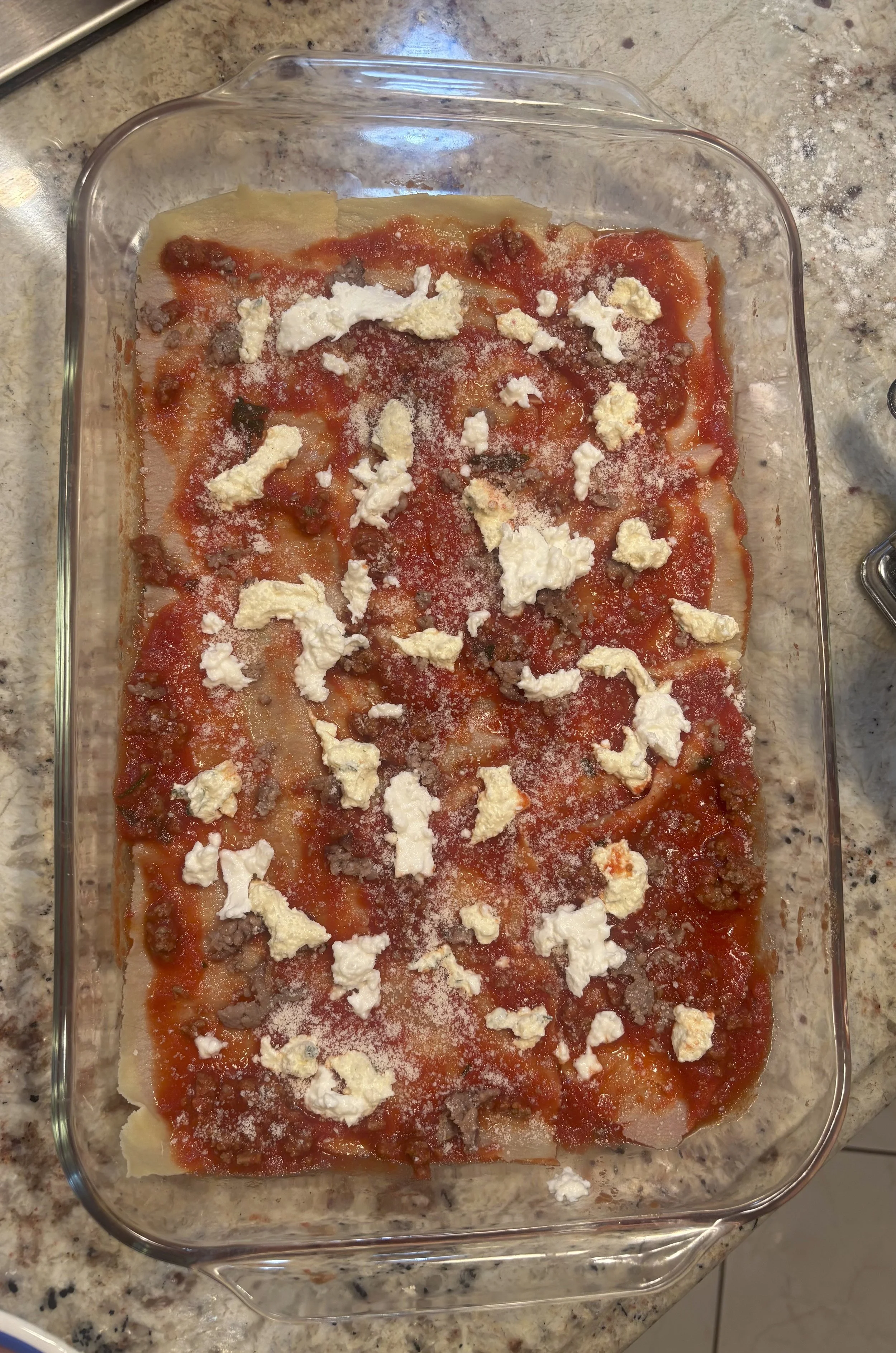 After scooping sauce, add in blots of ricotta and mozzarella.  Sprinkle sausage sparingly
