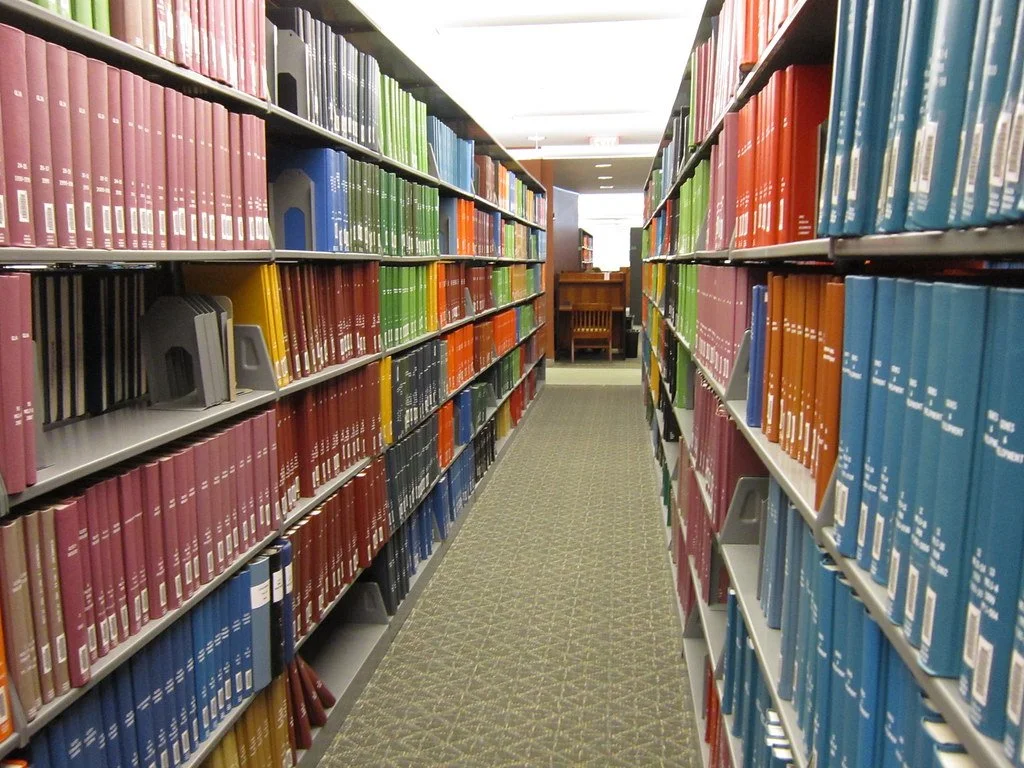 A rainbow of journals line the stacks in a health sciences library