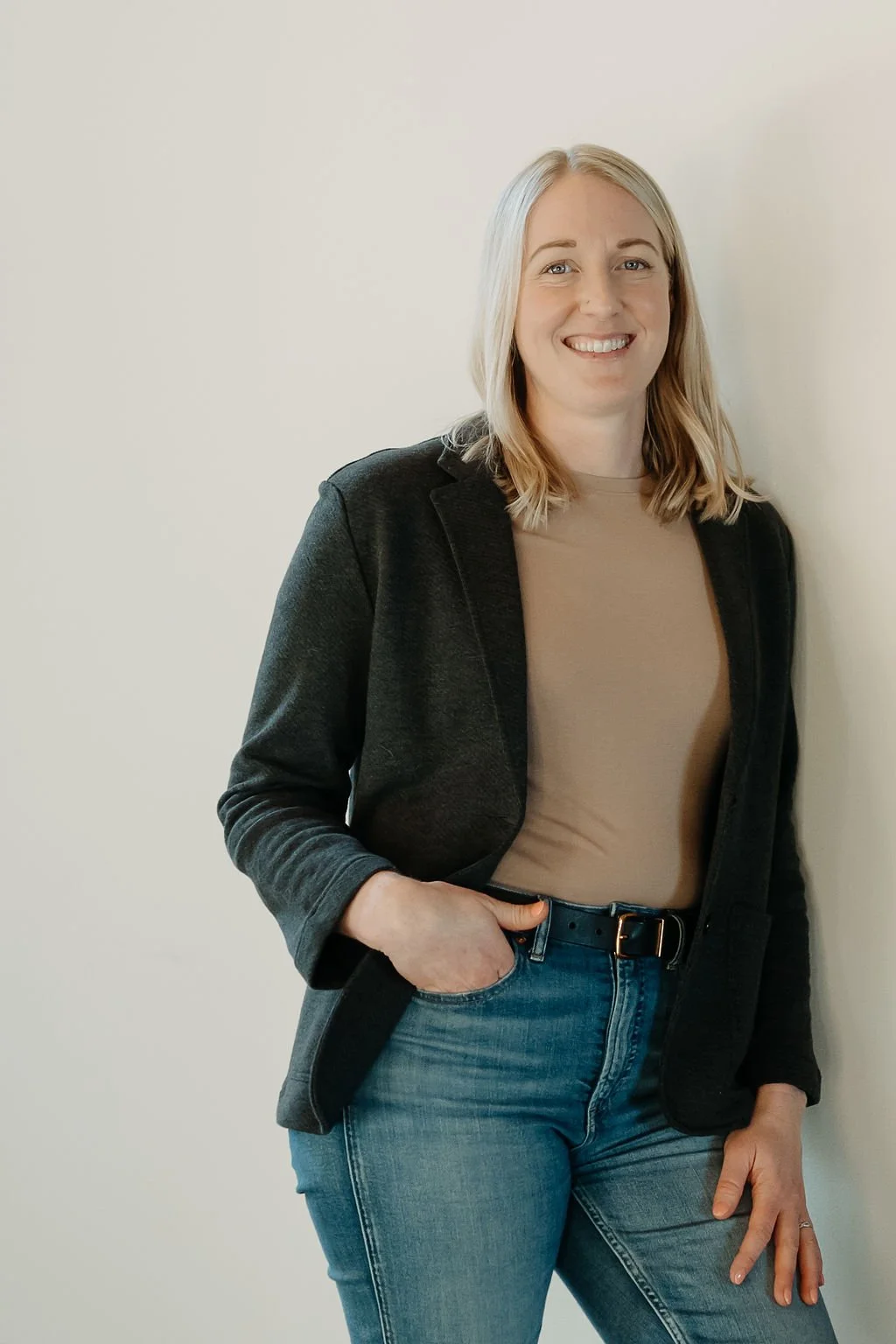 headshot of a blonde woman smiling at the camera