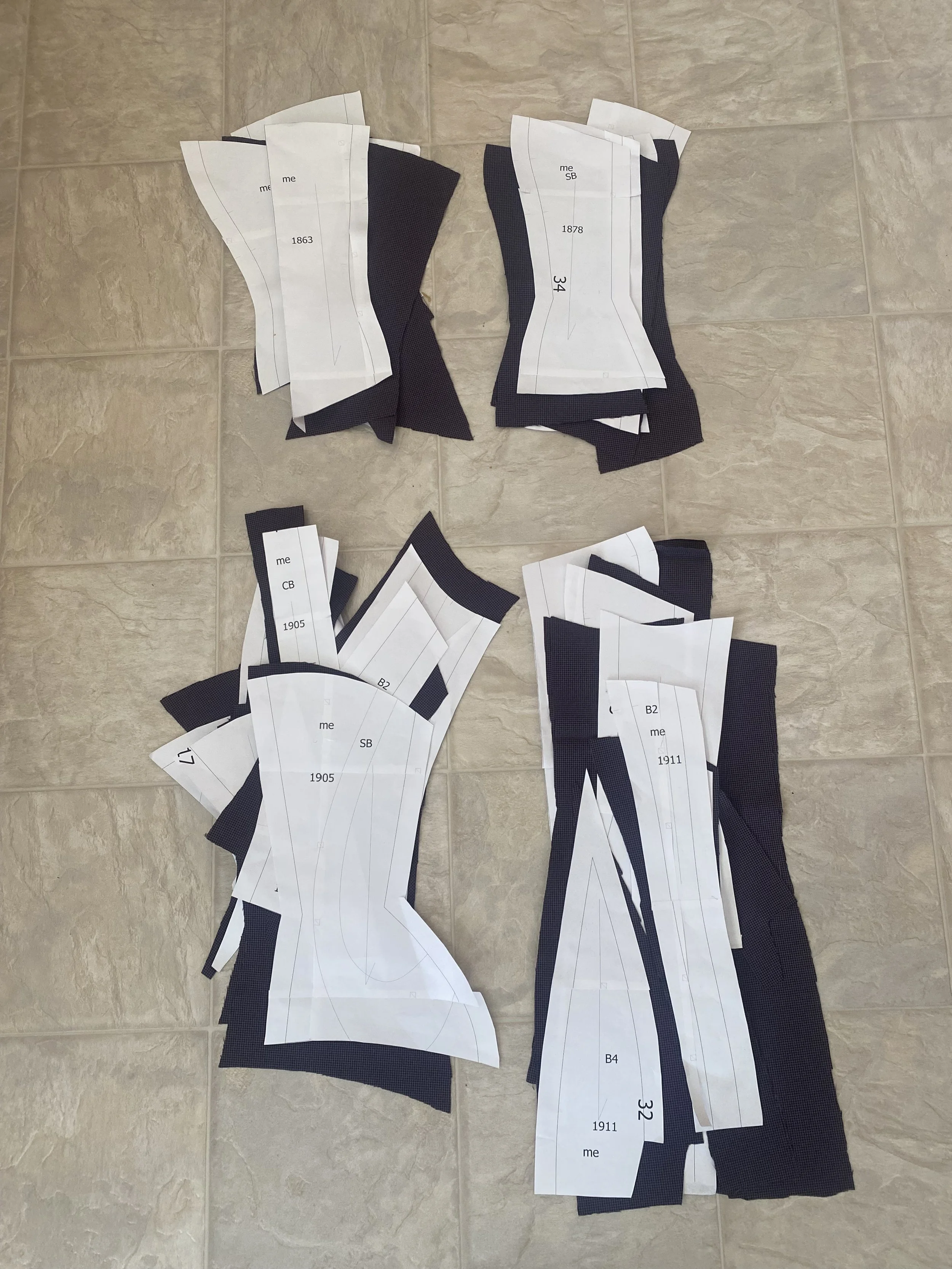 Cut mock-ups of four corsets