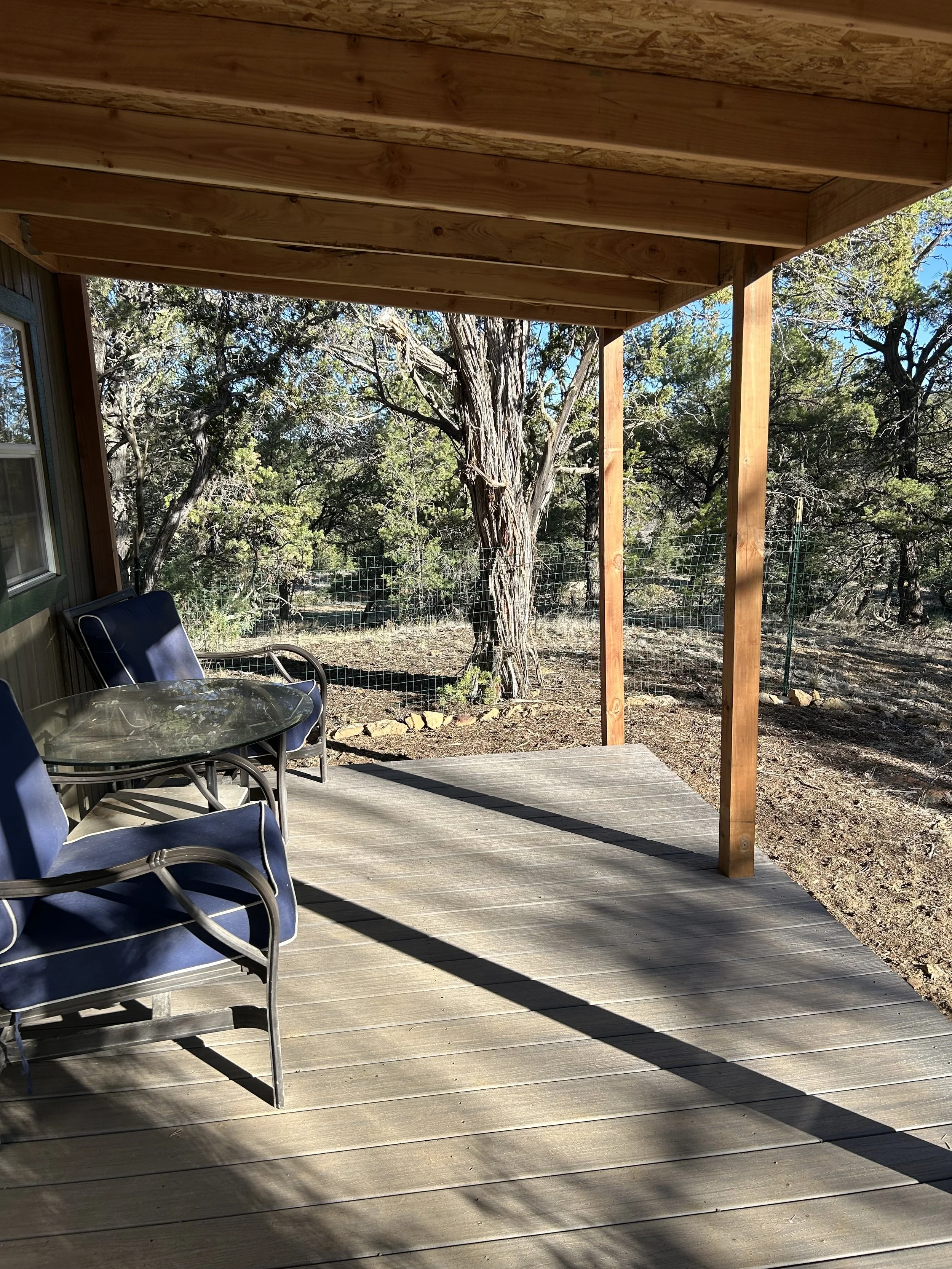 8ft wide by 20ft long covered porch with seating to enjoy the beautiful surroundings. Outdoor seeing provided w/small table