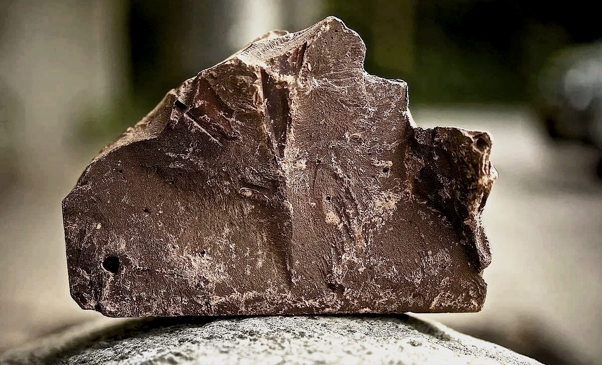 A large, irregularly shaped ceremonial cacao block The Heart of Cacao