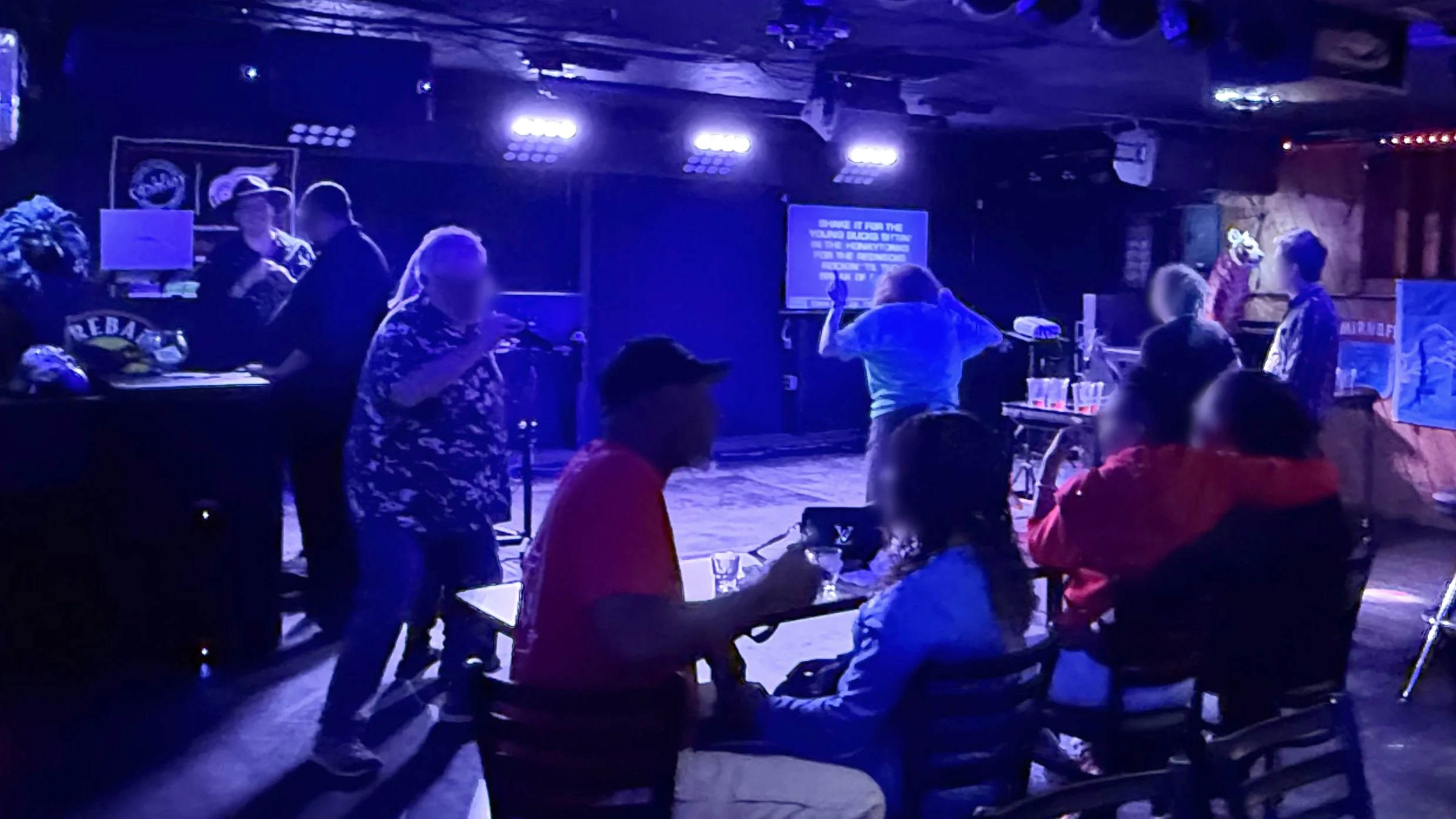 Karaoke night inside Log Cabin in Grand Rapids, Michigan, showing the crowd, stage area, lyric screen and colorful lighting during the GRkaraoke.com Karaoke Marathon 2026
